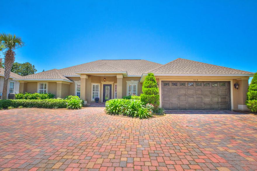 Custom built one story home with large paver driveway leading to the home. The largest lakefront lot in this gated community. Beautiful entrance to the home with a glass front door. Front porch, two car garage with opener, paver walkway to back lanai. Hot tub, outside shower, extra electrical outlets for someone that might want extra lighting or to add a pool. Home has rod iron fence on east side of home. Flood lights. Hardwood and tile floors, granite countertops with stainless appliances. Plantation shutters throughout. Refrigerator does not convey. Eat in kit with windows overlooking the lake. Formal din rm, great rm with gas fpl, Fl rm, split bdrm floor plan. Master bdrm has tray ceiling and over looks the lake. Master bath has Jacuzzi tub and separate shower. 6x15 master closet