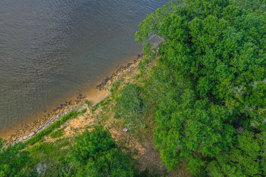 Welcome to your future home site! This beautiful vacant lot comes with 106 feet of serene waterfront on just under an acre, providing the perfect backdrop for your dream home. Recently bush hogged, the property features beautiful trees and a canvas for you to build upon.Situated on a generous parcel, this lot offers a unique blend of natural beauty and potential. A portion of the property includes a partial wetland, adding to the charm and ecological diversity of the landscape. Survey available. Listed below recent appraised value!