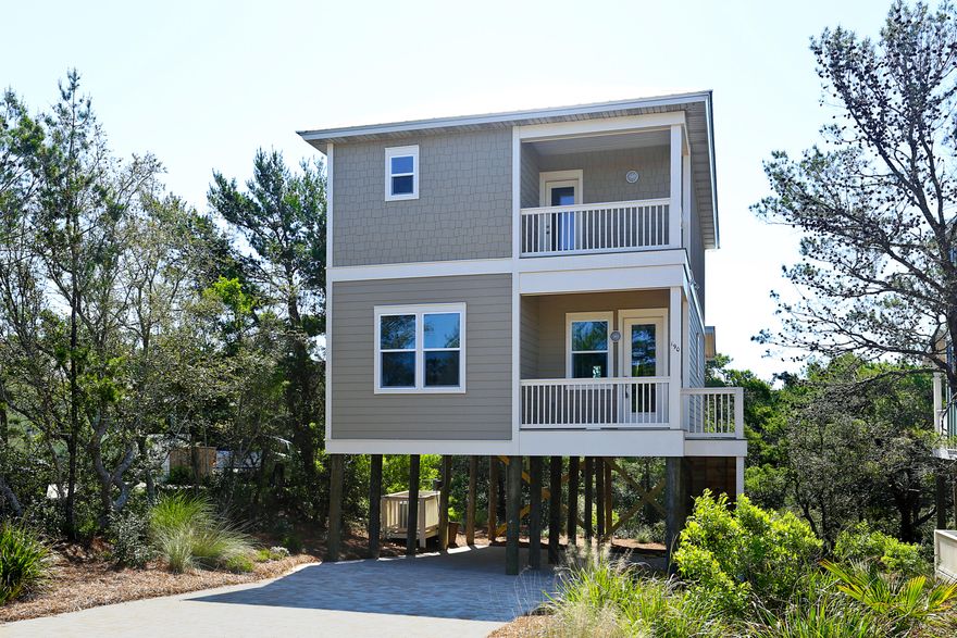Beautiful 2 story home on pilings just a block from the beach. This 4 bedroom 4 and a half bath has a great layout. Downstairs has one bedroom with a huge living area and kitchen. Upstairs hosts 3 bedrooms and all have their own bathroom inside the room. hardwood throughout the house with tile work in the bathrooms. Granite throughout, stainless steel appliances, impact windows and doors... this home has all the finishes you are searching for.