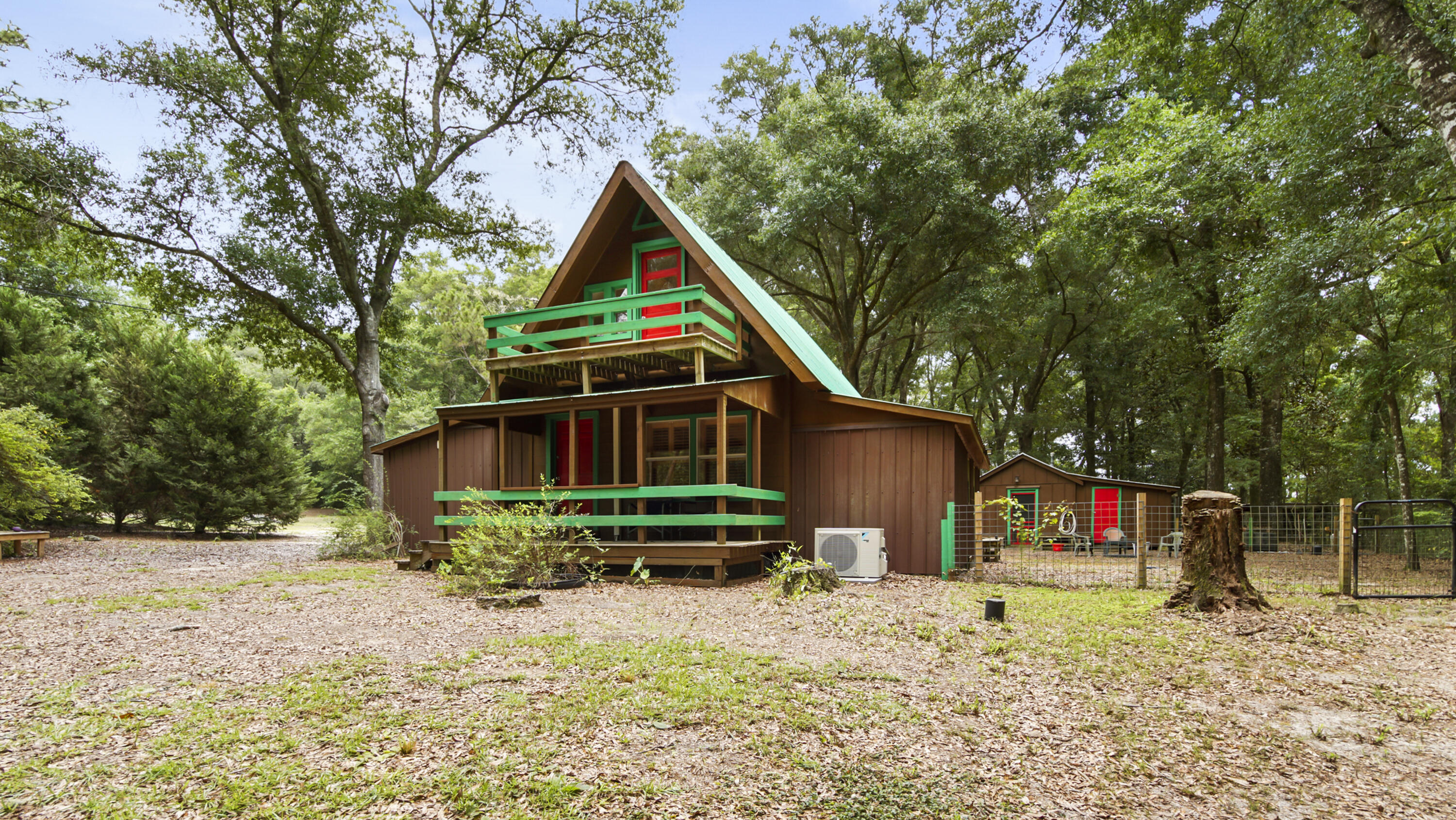 Nestled on 7.34 secluded, wooded acres, this unique 2-story cabin offers 3 bedrooms, 2 bathrooms, and 1,364 square feet. Perfect as a full-time residence or weekend escape, this property combines rustic charm with versatile amenities for a variety of lifestyles. Outdoor features include a dedicated dog training area, a dog agility training field, and a private pistol range. This is a rare setup ideal for animal lovers, trainers, and outdoor enthusiasts alike. With open acreage, wooded privacy, and room to expand, this property is full of opportunity. A private driveway leads to the home, where you'll find a carport and an additional detached building currently used as a storage area, and laundry room, offering incredible flexibility for homeschooling, workshops, or extra space. Walking distance to Ponce De Leon K-12. Whether you're looking to unwind in nature or create a multi-use homestead, this property delivers both peace and potential. Schedule your showing today and come experience the freedom of country living!