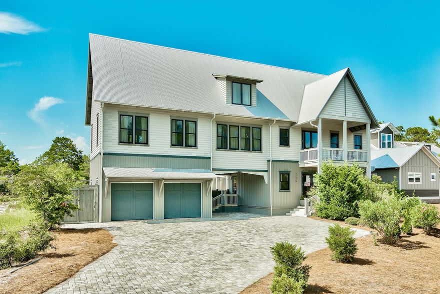 This amazing 4-bedroom, 3.5-bathroom home with a private pool and two-car garage backs up to Point Washington State Forest and is for sale in Seacrest, FL. Built in 2012, this newer home has everything a family will need for a full-time home or vacation home. There are no HOA fees and this home can be used as a vacation rental investment. Easy beach access is located nearby. Modern gray hardwood floors run throughout the living areas. The fully equipped kitchen, dining area and living room - with soaring, vaulted ceilings - are an ideal place for family get togethers and entertaining. The kitchen has white quartz countertops, custom cabinets, which hide the countertop appliances, and Thermador stainless appliances. A large stainless farm sink and breakfast bar complete the modern kitchen.