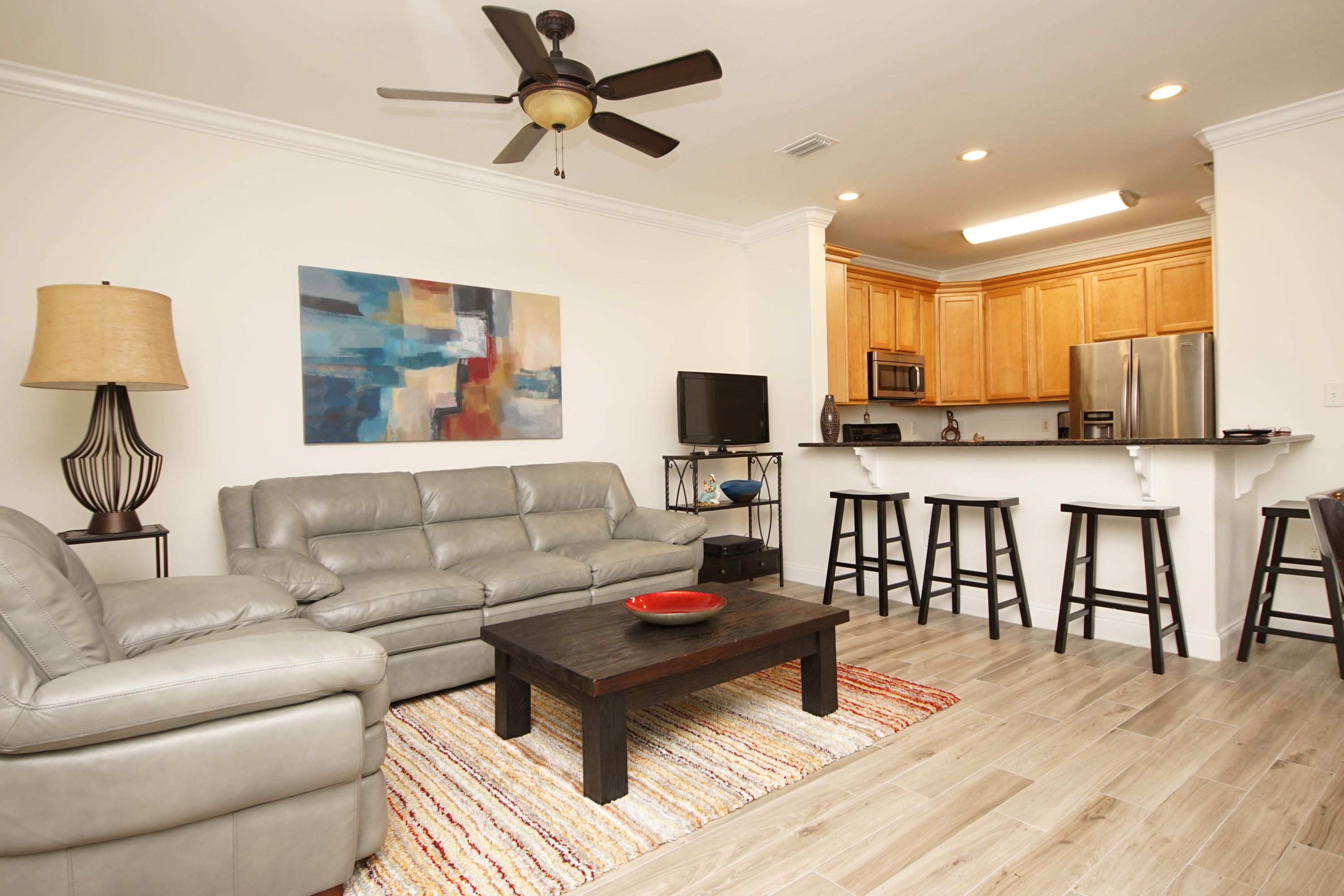 Doesn't get any better than this. Lovely well maintained Townhome with neutral colors. This unit shows well and offers solid surface counter tops in the kitchen, a breakfast bar, recessed lights and stainless steel appliances. There is crown molding in the living room and a door that provides access to the covered back porch. All bedrooms are upstairs. Why rent when you could own this gem? New Wood TIle flooring and updated appliances make this a great value! Well kept home awaits your purchase!NEW HVAC in 2017 (inside and outside units) New Microwave in 2015, new Refrigerator in 2013.