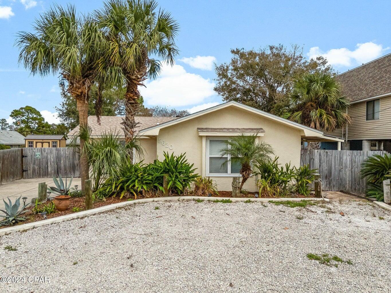 Welcome to this quaint Florida Cottage home on the East end of Panama City Beach, located just two blocks away from the beautiful white sandy beach! Enjoy living the laid back coastal lifestyle with the close proximity to local shops, restaurants, and bars! This home comes Fully furnished and NO HOA! In the front of the property there is a detached building where you will find the laundry and oversized storage room. This home sleeps up to six people, has a fully equipped kitchen with granite countertops. The backyard is a private oasis with a covered patio and an elegant wooden bar area. There is plenty of room to add a pool if you choose to do so. Use this home as your primary residence or make it your next investment property! Please note this home is currently on the rental program with Vacasa.
