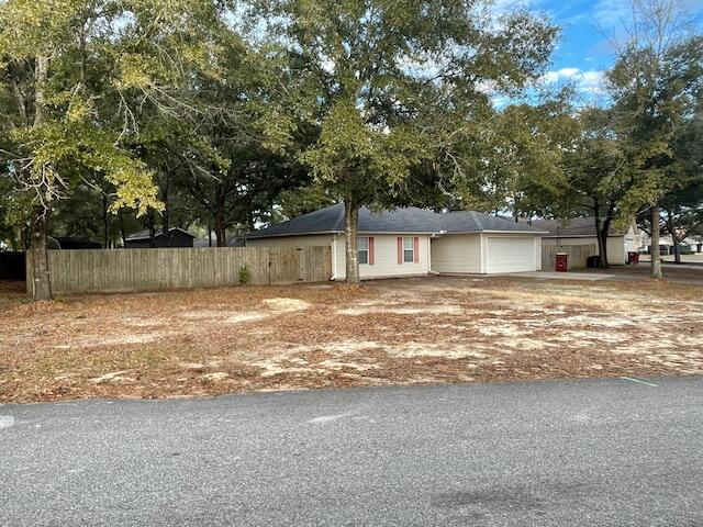 This Neat, Affordable home on a level lot in a convenient location near shopping, restaurants and healthcare, has been very well maintained.  Cathedral ceiling and corner fireplace (looks like it has never been used!) accent the living room. .New Carpet.   Spacious Master Bedroom has a coffered ceiling and a 6 x 3'7 walk-in closet. The hall bathroom has a linen closet. The kitchen has a lot of cabinets and all of the appliances are included, even the washer & dryer; appliances ''AS IS''.  Roof, 2020, HVAC 2024, HWH 2025,  Privacy Fenced back yard  and is spacious.  Off a main drive, quiet but very convenient to all points South.  This .32 Acre Lot is irregular, but has a WIDE front, and spacious side and back yards enclosed with a 6 ft. privacy fence.  What many want, convenient to the South end and Bases, yet has easy, low traffic access to all points North!