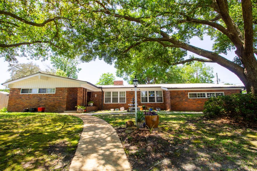 Offering four bedrooms and three bathrooms, and over 2,500 square feet of living space, this residence blends timeless charm with modern updates and functional living. Step inside to find a warm and inviting layout featuring a formal living room, dining area, and a large family room centered around a dual-sided fireplace, which was completely updated in 2023. The kitchen opens into the family room, making it ideal for entertaining or enjoying cozy evenings at home, and features a 2 ovens and a gas stove for the home chef. A bright and airy Florida room adds additional living space and is perfect for relaxing or hosting guests, with updated windows installed in 2023 to enhance comfort and efficiency.Buyer to verify all information deemed important. The fourth bedroom has been thoughtfully converted into a dedicated office space, with the door removed to create an open and flexible layout. It can easily be converted back into a private bedroom if desired. Throughout the home, you'll find a mix of hardwood, tile, and vinyl flooring. Built-in bookcases and recessed lighting add charm and functionality.

Additional upgrades include a tankless gas water heater, a 2016 roof, and a sprinkler system that runs off a private well for cost-effective lawn care. New gutters with guards have been installed for low-maintenance exterior upkeep. For added storm protection, the home comes equipped with fabric shield coverings for all windows and exterior doors. A 10x10 shed in the backyard provides extra storage for tools, lawn equipment, or hobbies.

Situated on a large corner lot, this property offers privacy, curb appeal, and outdoor space for entertaining, gardening, or relaxing under the shade of mature trees.