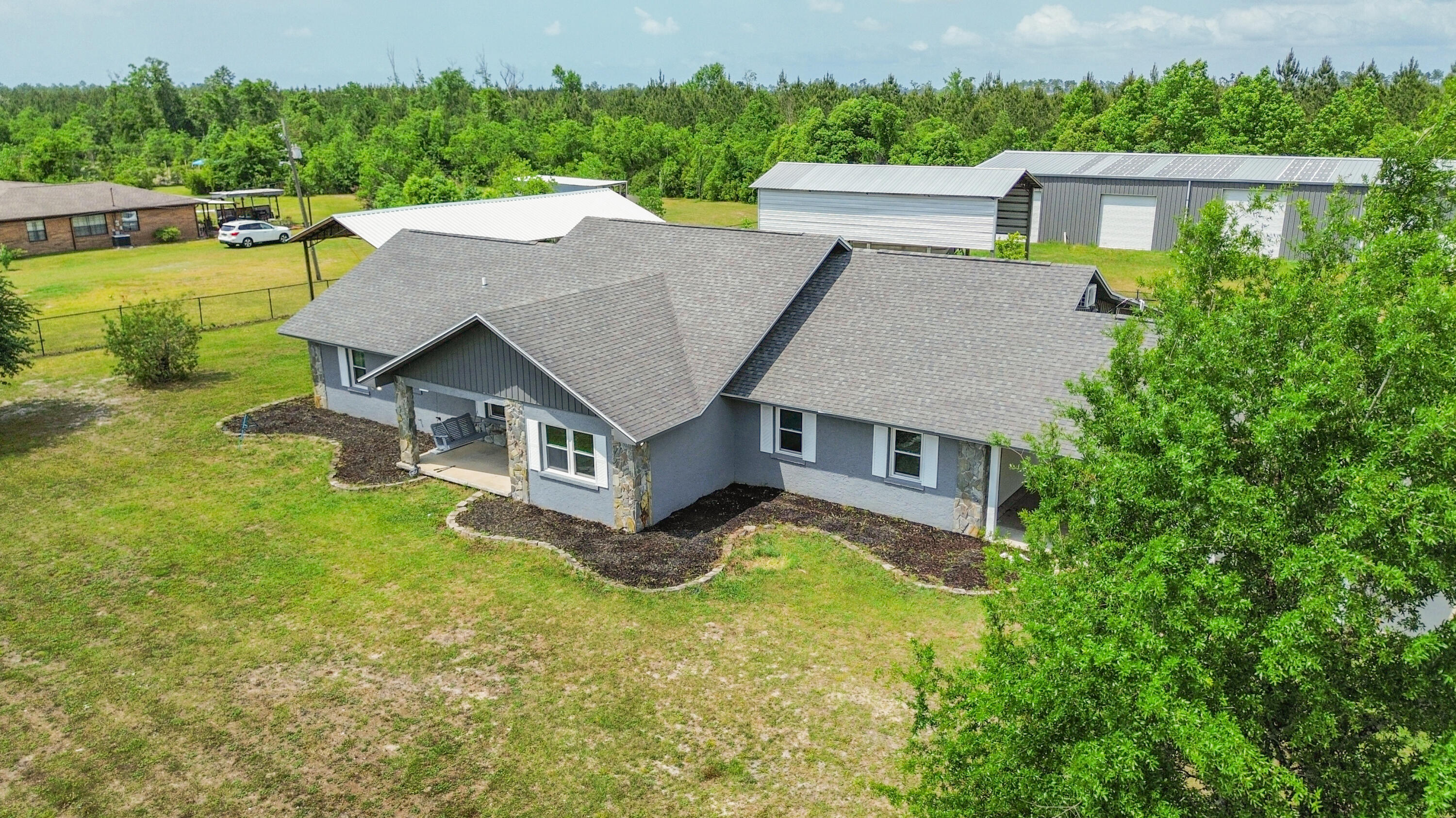 This 3-bedroom, 3-bath property includes over 2,500 square feet of thoughtfully designed living space, complete with two bonus rooms and two separate family rooms.Inside, you'll find a neutral palette, luxury vinyl plank flooring, refreshed countertops, updated sheetrock, and interior paint -- all completed in 2023. The main living area features vaulted ceilings with exposed wood beams and connects to a cozy dining nook and a generous kitchen with modern touches. A second family room offers even more space to relax or host gatherings. The oversized primary suite includes a private bath and an attached sitting room, perfect for a glam room, reading nook, or nursery. Two additional bedrooms and two full bathrooms are perfect for family or guests. The two versatile bonus rooms are ideal for a home office, playroom, exercise room, or guest suite.
Outside, enjoy a large, flat lot with a fenced yard, pole barn, covered patio, and carport, plus plenty of room to park your RV or boat. Located just off Titus Road in a peaceful area, this property is close to schools, shopping, and Deer Point Lake.