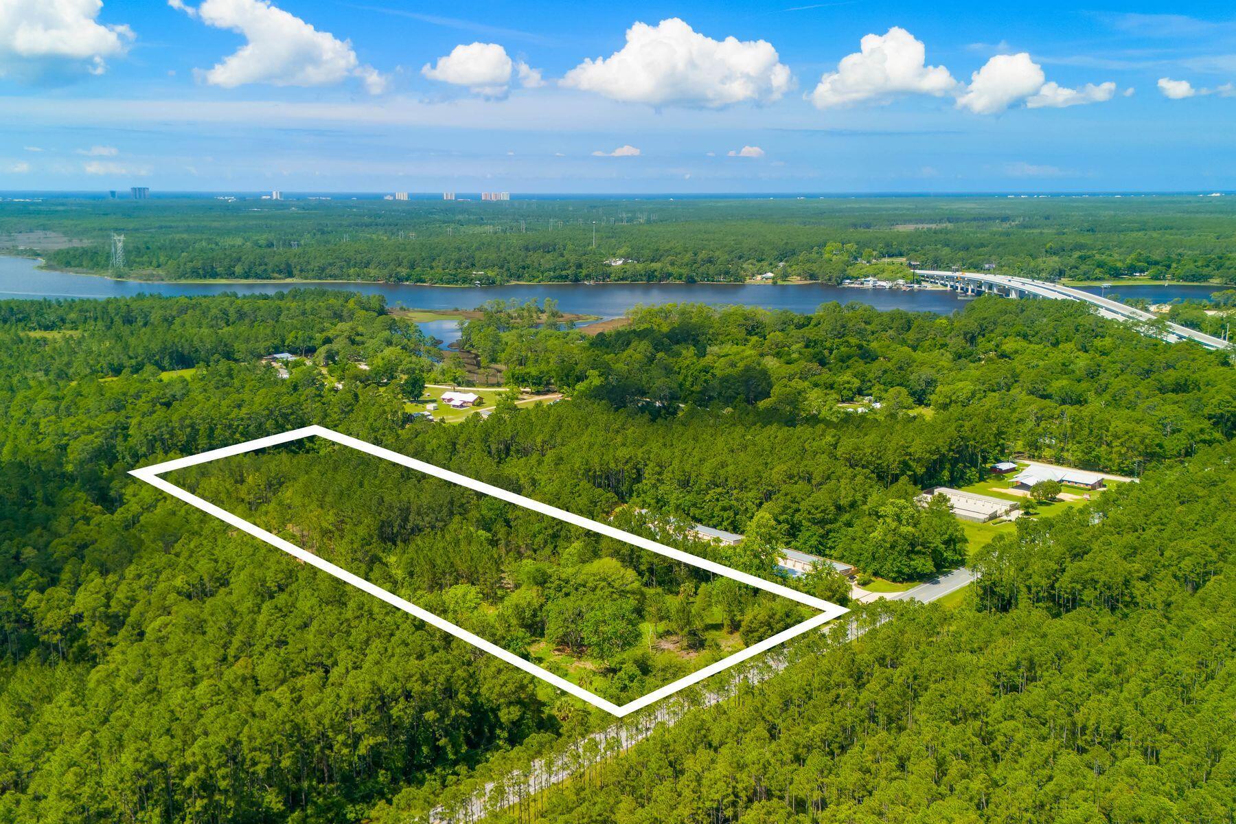 Discover an incredible opportunity with this 8-acre property located in one of the most rapidly growing areas of Panama City Beach. Zoned WBC (West Bay Center) within the West Bay Sector Plan, this property offers exceptional flexibility for a wide range of development possibilities. At the rear of the property lies a picturesque pond, an ideal focal point for a future community amenity or serene natural retreat. Strategically positioned, this property is just two miles from the bustling Northwest Florida Beaches International Airport and one mile from thriving Latitude Margaritaville Watersound, a vibrant 55+ community poised for significant expansion. Its proximity to the newly established Tallahassee Memorial Healthcare Hospital and a growing commercial hub enhances its appeal. Adjacent to the upscale RiverCamps on Crooked Creek, the property benefits from a tranquil and desirable neighboring community. Utilities, including water and sewer, are conveniently located nearby, providing the essential infrastructure and flexibility for a visionary development. Whether you're envisioning a residential enclave or exploring the possibilities of commercial ventures, this prime acreage combines natural beauty, a strategic location and limitless potential to bring your vision to life.