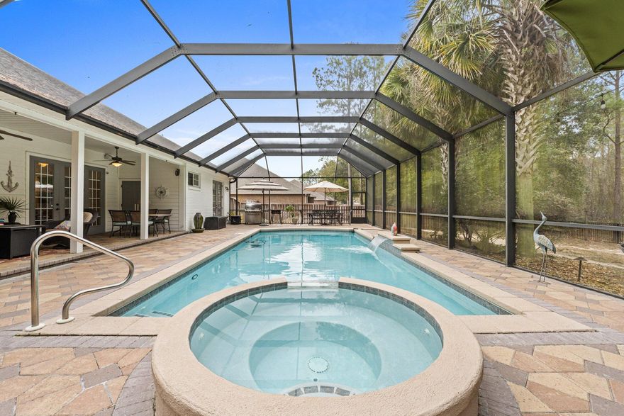 Only 17 miles to Blue Mtn Beach on 30A, this custom Turner Heritage home in ''Harmony at Hammock Bay'' has an excellent floor plan, three car garage, and backs to a lush, private nature preserve! Harmony Way is a beautiful cul de sac located less than 5 miles from two waterfront marinas (with boat storage and direct access for boating) on the fabulous 32 mile Choctawhatchee Bay! This home features an enclosed lanai over the heated saltwater swimming pool/hot tub and a wonderful outdoor living space with .58 acre fenced yard. Perfect for entertaining, your large and inviting great room has a fireplace with mantle and custom granite wine bar with storage.  Ample cabinetry, Kitchen Aid appliances, including an induction stove top and plenty of counter space, will please even the most discriminating chef. The wide covered patio is an extended living room and the perfect spot to end a beautiful dinner party. Spacious primary suite enjoys  a view of the pool, tray ceiling, separate shower and soaking tub, as well as custom built-ins in the primary closet. Separate dining room and office are both generous in size and located at the front of the home, off of the impressive foyer/entry way.  The three car garage and long driveway is a must these days and can house two cars, a golf cart  all all your kayaks, tools and sporting equipment. Laundry with sink, folding area and cabinetry evan has room for an extra fridge or freezer. This home enjoys two natural gas hot water heaters, a natural gas pool heater, and two electric heat pump HVAC units. Your lawn irrigation is provided by your own lawn pump with water softener.  Situated in Hammock Bay, this magnificent home will provide the lifestyle you envision! Convenient to all amenities and Hammock Bay's miles of trails and sidewalks, this home has it all! Hammock Bay has an amazing Events Coordinator, so something fun is always happening, such as holiday celebrations, the farmer's market, parties, movies, etc. World-class amenities include Props Brewery in Town Center and two new clubhouses coming soon, one of which will be on our Bayfront parcel for enjoying our wonderful sunsets! HOA fee of $559.35 quarterly includes basic cable and all common existing amenities of Hammock Bay. These amenities include the 24/7 8,000 SF fitness facility; owners' club with theatre, caterer's kitchen, and party space; three swimming pools, tennis, basketball, 4 lit pickle ball courts, playground, bayfront club house, (soon, a 3rd clubhouse with pool and kayak launch), fishing pier, 60 acre sports complex, outdoor amphitheater with spectacular LED TV for concerts and sports, two dog parks, and well, just too much to list. Buyer to verify all square footage and information important to them. This one won't last long at $280.55/SF. Call for a private showing and come see your new home at 115 Harmony Way!