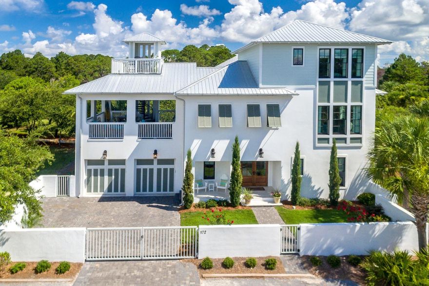 This beautiful, never been rented home, sits on the largest lot in lovely, gated Seanest Village. Deeded, easy beach access, gulf glimpses, steps to the neighborhood pool and a short bike ride to Seaside. Offered furnished with a few exceptions, this home boasts 4 bedrooms and 3 1/2 baths. Enjoy hardwood floors throughout, a modern gas fireplace, and a large chefs kitchen with beautiful quartz countertops, a gas range, and double oven. The open concept living/kitchen/dining room with abundant windows opens up to a spacious 540 SqFt porch with summer kitchen, large dining and sitting areas and a spiral staircase to an open air deck with Gulf views. Lovely Master suite offers a large closet and stunning en suite master bath.