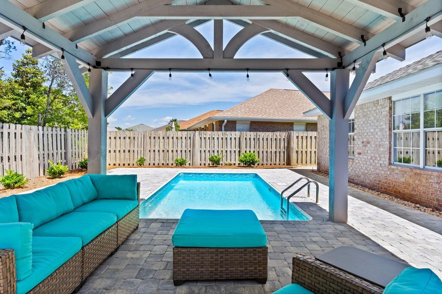 Deeded beach access and 320' of private beach area make this coastal retreat a rare find! Located in the private gated Paradise Retreat neighborhood just down the street from the white sandy beaches, this fully furnished, turn-key ready home also boasts a brand-new pool and deck installed in 2024, surrounded by beautiful pavers that extend around the entire home. The backyard features a spacious pavilion equipped with electricity - perfect for outdoor entertaining, lighting, or even setting up an outdoor kitchen and TV area.Whether you're seeking a primary residence or a short-term rental (sleeps 8), this property offers the best of both worlds. Inside, the inviting open-concept layout features vaulted ceilings, stylish wood-look tile flooring, and a kitchen designed for hosting with an entire wall of cabinetry, stainless steel appliances, and a large center island that is perfect for entertaining.

The home includes three bedrooms and two bathrooms: a master suite with a king bed and double vanity ensuite, a second guest bedroom also with a king bed, and a third guest bedroom equipped with double bunk beds-perfect for kids or extra guests. The guest bathroom features a tub/shower combo and a new vanity.

Additional highlights include a separate laundry room, two-car garage with built-in cabinets and an entertainment center with a mini fridge and wine rack. This move-in-ready gem combines laid-back beach living with all the features you need for comfort, entertaining, and investment potential.

It is located right off Scenic Highway 98 which provides the ultimate golf cart lifestyle.  Cruise along this beautiful scenic route to popular local favorites like Camille's, Crab Trap, Captain Dave's, and Pompano Joe's, or grab your coffee and head to the sand for sunrise.

