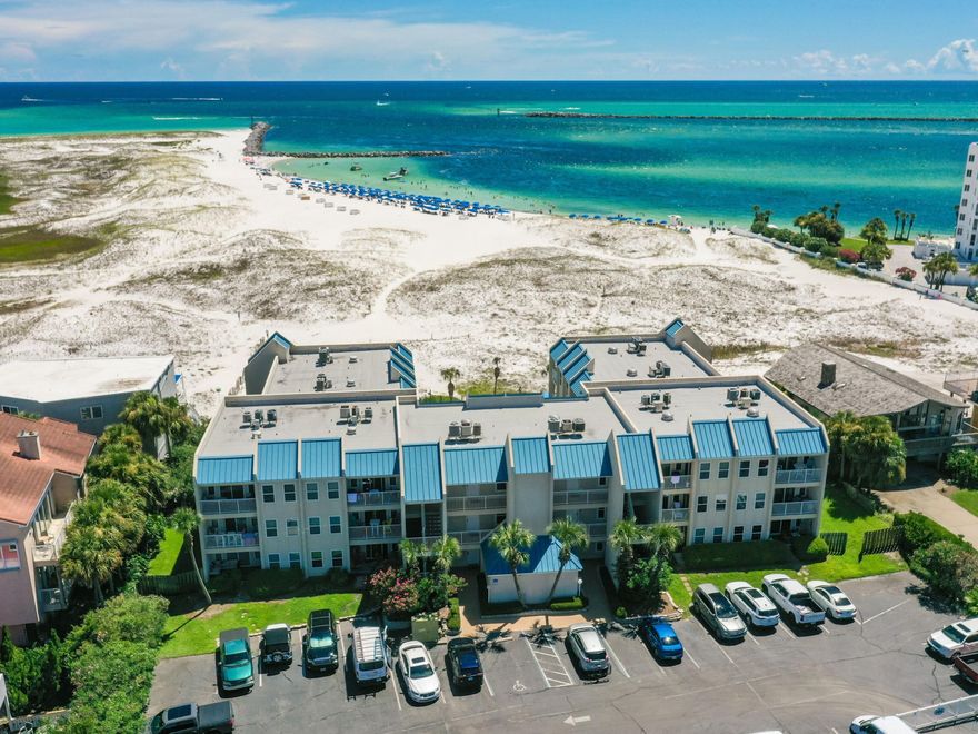 Fully renovated and ready to welcome you and your guests, this stunning gulf-view condo is situated on a peaceful corner of Holiday Isle. It's so close to the sugar-white sand and emerald gulf waters, you can almost feel the sand between your toes as you relax on the balcony or sunbathe by the pool. This spacious fully-furnished condo has an open floor plan and a contemporary feel, thanks to the modern wood plank vinyl flooring and earth-to-ocean color palette. The all-white kitchen with its tile backsplash is ideal for rustling up pancakes for breakfast or serving dinner at the nearby dining table. There's even a washer-dryer tucked away in its own closet. Two spacious bedrooms and two baths make this an attractive vacation home or rental investment.