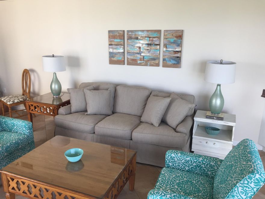 Sophisticated coastal decor greets you as you enter this beautiful gulf front condo. The turquoise accents reflects the waters from the gulf of Mexico providing a cool, relaxing, comfortable beach-y atmosphere. The spacious kitchen features a large granite breakfast bar overlooking the dining and living area. This 3 bedroom end unit has lots of windows and amazing views and features a lock-out, so it can be rented both as a 2 bedroom or a 1 bedroom, 1 bath with kitchenette - perfect guest suite or mother-in-law suite. This flexibility makes this a great rental income producer or second home. Top of the line hurricane shutters operate with a touch of a button and provide added protection. This unit is rental ready, just bring your bathing suits and enjoy the coastal lifestyle!