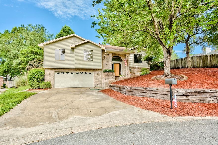 Located in the highly sought after neighborhood of Rockywood, this home is central to all shopping centers and close proximity to the bayou and Rocky Bayou Golf Course. Columns frame the front door with side lights and arched transom providing a warm and inviting entrance. A recently remodeled kitchen boasts elegant features, a gas fireplace with accent lighting over the mantle for a cozy feel in the living room, and an additional bright and airy sun room overlooking the in-ground pool. A desirable outdoor entertaining space enclosed by a lanai features the extended deck leading to a fresh water pool. This home includes 3 main floor level bedrooms, with an additional  mother-in-law suite located on the bottom floor accessed by a private entrance, perfect for guests or a fourth bedroom.