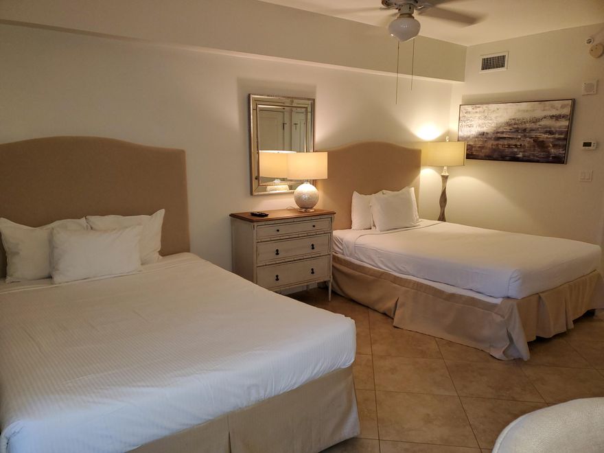 Welcome to this 2nd floor studio in the Grand Sandestin. With two queen beds & kitchenette, this could be your next residence or investment property. The tile flooring offers easy cleaning after a day at the beach or the nearby pool. A fully stocked kitchenette provides a microwave, mini-fridge, and sink. Enjoy your cup of coffee while watching the guests pass by from your balcony.  The Grand Sandestin welcomes you with gracious architecture and luxurious amenities including a fitness center, swimming pool, & on-site check in. Enjoy the location adjacent to the Village of Baytowne Wharf, a pedestrian market place that hosts a variety of dining and shopping venues as well as day & night activities for all ages