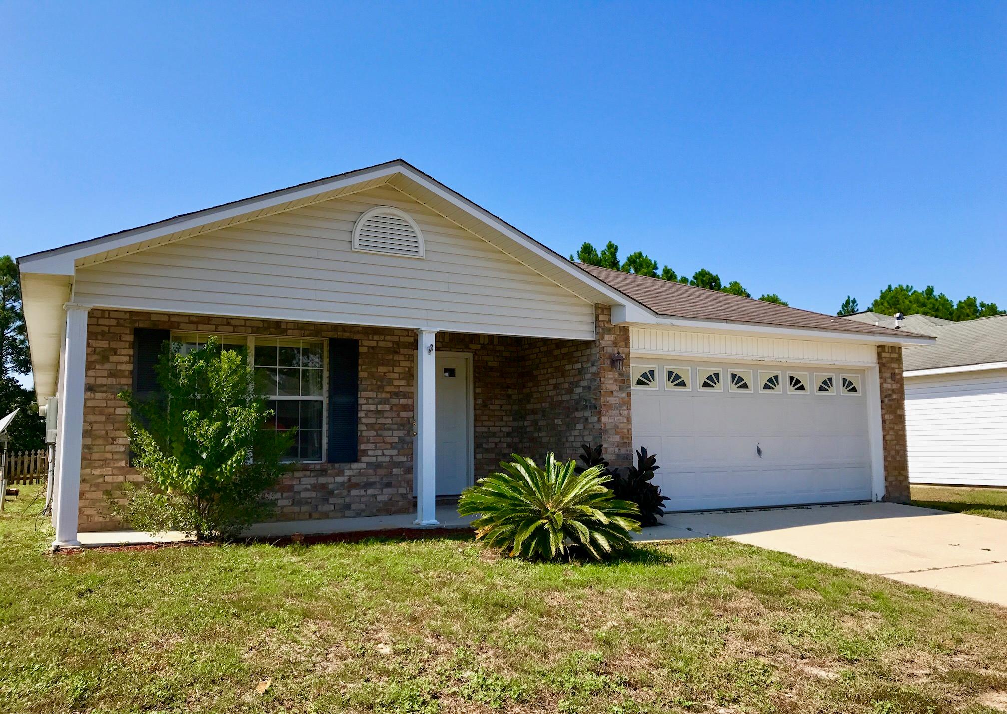 This spacious 4 bedroom LAKE front home in the popular Hidden Shores neighborhood is just what you are looking for! It is completely move-in ready; NEW CARPET, FRESH PAINT, NEW MICROWAVE, NEW STOVE and MORE! There is hardwood flooring just inside the entrance as well as in the dining area. Carpeted in the open living space and bedrooms. The split floor plan includes a private oversized master bedroom and a HUGE walk-in closet. The kitchen is light and bright with plenty of cabinets and counter space. It also includes a center island, desk area, pantry, fireplace, breakfast area and tile flooring! Glass sliding doors lead out from the kitchen area to the fenced-in backyard and patio, overlooking the community's scenic lake. Convenient to the military bases and both Navarre and Gulf Breeze! Just West of Holley By The Sea, very convenient access to 98.