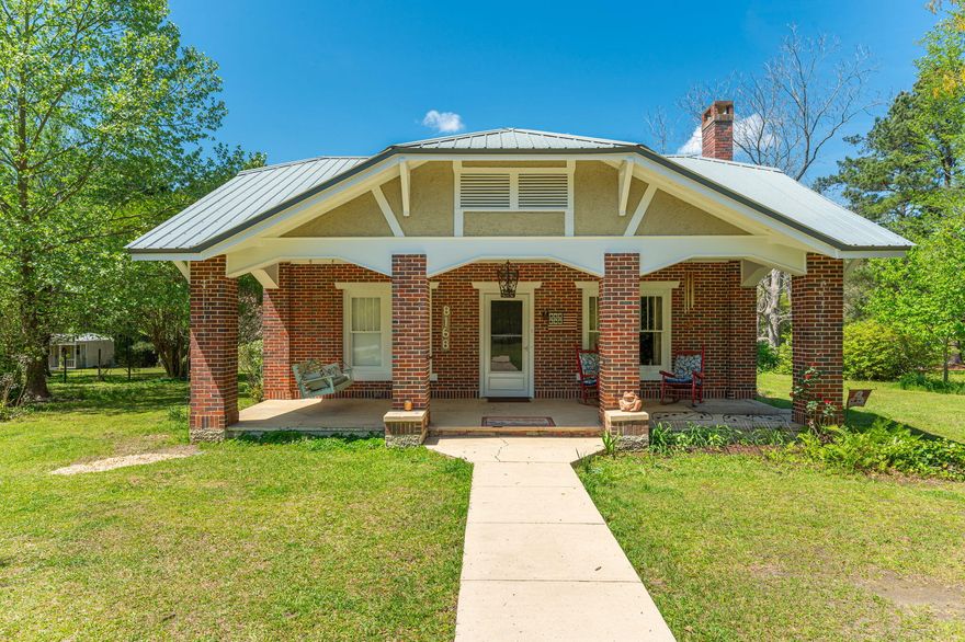 If you are looking for a beautiful home with space for all of your toys and animals, you must see this property. This classical country home features a brick exterior, metal roof and a wonderful front porch that is perfect for sitting in the swing and watching the wind blow.  Property is partially fenced and cross fenced so is ready for your horses. This home has been wonderfully maintained and updated and shows the pride the owners have in his family home since it was built.  Wonderful back porch with sink perfect for an outdoor kitchen. Be in the middle of downtown Laurel Hill with almost 5 acres to enjoy your space in peace. This listing also includes parcel number 05-5N-22-2510-0018-0020. New HVAC system installed and original hardwood floors have been professionally refinished.