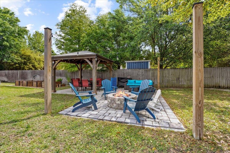 Get ready for this wonderful 4 bed 2 bath home sitting on a 100x200 lot only minutes from the Elevate Navarre center with shopping and restaurants and the stunning sugar white sands of the Gulf of Mexico. This beautifully curated home is move in ready with wood plank tile flooring in the main living areas and plush carpet in the bedrooms. It has a welcoming foyer and formal dining, with a large family room with vaulted ceilings, built in entertainment center, and large patio doors that lead out to your spacious back yard for all of your entertaining needs. The kitchen has a breakfast bar and nook with builtin cabinets. Gorgeous granite for all your cooking or sour dough starter needs! Theres also ample cabinet space, SS appliances and a large double pantry with built in wood shelving.  The primary suite is a great size with a tray ceiling. The bath offers a double vanity, large soaking garden tub, step in shower and wide walk-in closet. The other beds are great for family, guests, or gaming; all of which contain oversized closets. The laundry room has extra storage space and shelving which leads to the 2-car garage with drop down attic stairs. Side yard to the home has double gates to the back yard for easy access and could easily accommodate an RV or boat. The back yard is an entertainer's dream! It has a covered patio that can be used to grill and entertain with an extended uncovered paver patio. To the left there are raised garden beds to assist in your culinary delights. Additionally, there is a covered patio area next to a fire pit to enjoy all of those summer nights with friends and family. The back center houses a large metal shed for your storage needs. In the back center is a large live-oak tree that provides shade and decoration. There is also a children's play house that conveys with the property for our younger home owners to enjoy their new home after those long days at school. The home is wired for a generator. The sellers also have a generator available for purchase to power the WHOLE HOME if desired. 
