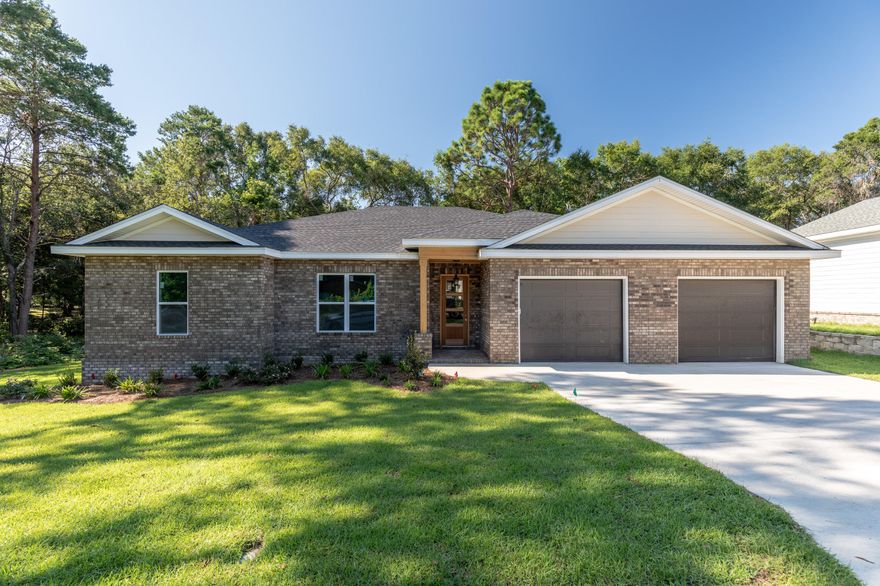 Beautiful brand new construction in the heart of Valparaiso just minutes from water access and Eglin AFB. Incredible quality of construction boasting 2x6 wall studs for stronger framing and additional insulation, sturdy brick siding and fiber cement board siding, and impact glass windows up to 150 mph rating. Gulf Power certified energy efficient ''Earth Cents'' home, GAF heavy duty 30-year shingles, whole house automatic generator, Goodman heat pump air conditioner, Rinnai tankless hot water heater, spray foam insulation in roof, manabloc plumbing system, 10 foot ceilings, LED lighting throughout, and waterproof flooring. Kitchen is loaded with stainless steel Maytag energy efficient appliances, large farm house sink and tiled back splash. Kitchen and bathrooms offer custom cabinets built