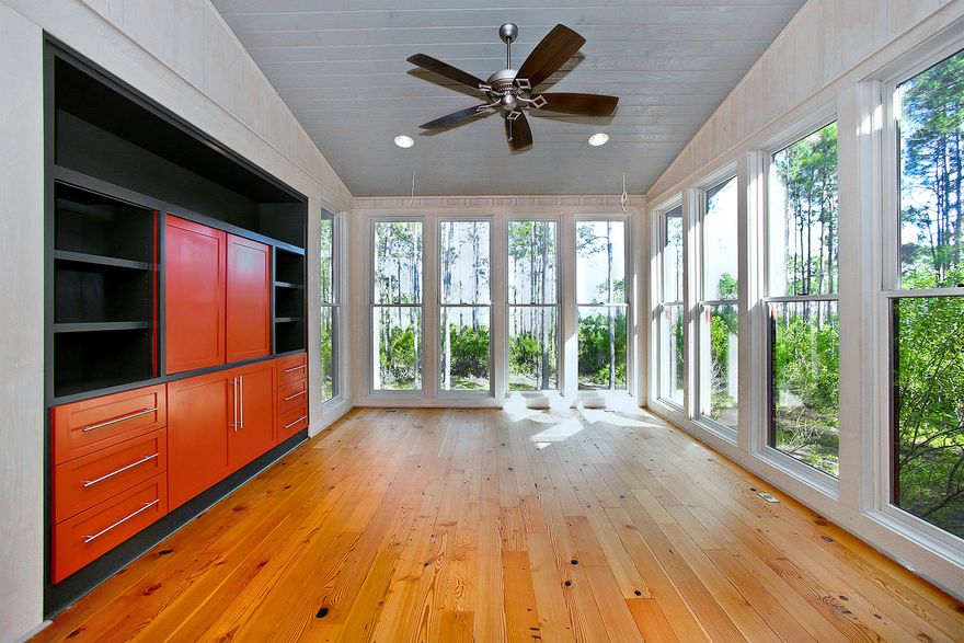 Gazing towards West Bay through a stand of pines, this contemporary cabin is the only completed home currently available for purchase in Rivercamps. Set along the north shore of West Bay, its 1,500 woodland acres traversed by trails, as well as amenities that include a boat ramp, pool, and pavilion, encourage an active, outdoor lifestyle. Just east of Highway 79, this secluded refuge is convenient to the attractions of Panama City Beach, including its emerald waters, wide variety of shops and restaurants, and seasonal events. Equally convenient is access to Northwest Florida Beaches International Airport, only 12 minutes away by car. Modern applications of familiar finishes create fresh living environments with inviting atmospheres. Horizontal cottage paneling transitions into
