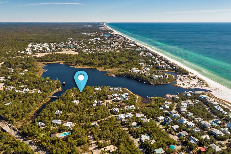 This exceptional homesite in Draper Lake Coastal Village, an Adirondack-inspired, gated community south of 30A, adjoins a protected natural area and is just steps away from the community's westside boat house upper deck, grass lawn play area, coastal observation tower and westside pool. This lot is at an elevation of 37 feet which will provide protection from high seas and offer views of Draper Lake through the trees once your home is built. Recent survey and previously approved architectural plans by Archiscapes are available. Draper Lake Coastal Village offers the epitome of the 30A lifestyle, with 40 acres of homesites, residences, trails, green space, and parks surrounding a rare Coastal Dune Lake. A 100-foot buffer along the lakefront ensures conservation and enjoyment of the lake by all residents. Additional amenities include a private beach cabana, a butterfly park and storage spaces in the boathouse for your paddle board, kayak, or canoe. Shops and restaurants are only a short stroll or bike ride away via the 18.5 mile long Timpoochee Trail which is adjacent to the Draper Lake community. The community allows no short-term rentals and requires no build out time.
A walking bridge spans the lake between West and East Peninsulas. Please note that there are two Bridge Cove Lanes. This lot is on the western side. The master design, in collaboration with Duany Plater-Zyberk, reflects their philosophy for modern urbanization. Create your dream gulf-side sanctuary on this beautiful homesite in this extraordinary community!  
