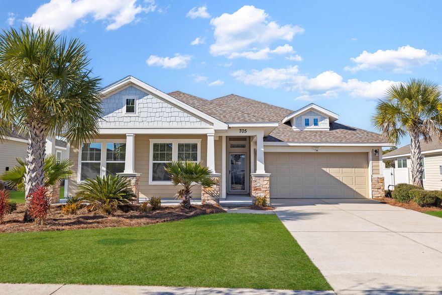 This spacious Craftsman-style home seamlessly blends generous living space with practicality. All on one level, it has an open-concept floor plan with a coffered ceiling and multiple windows. This bright and airy living space is designed for dining, entertaining and watching favorite movies together. The sleek wood-effect LVP flooring continues into a well-planned kitchen that showcases stainless steel appliances, including a new smart refrigerator and microwave. Granite counters and a mosaic tile backsplash enhance the workspace, while a vast granite-topped island with stool seating provides a generous space for sharing drinks, snacks, and social conversation. It easily accommodates the dual sink, dishwasher and drawer storage. A separate laundry room complete with shelving and a folding table keeps everything neat and tidy. The split floor plan comes into its own with four generously sized bedrooms. They offer ample space for additional furniture, while two full bathrooms provide everyone with privacy and space. The master suite is especially noteworthy, with a spacious walk-in closet. The private bathroom has a twin vanity and an updated walk-in shower with dual rain heads. Head outdoors to find a large covered patio, the perfect place to host weekend barbecues. The entire home is surrounded by fencing and lawns, allowing kids and pets to play safely. A wide driveway and a two-car garage offer parking and storage for vehicles, bicycles, tools and toys. Clearly well maintained, this delightful single-family home had a replacement roof in 2019. It's within easy walking distance of schools, parks and a local playground where kids can burn off their energy. The Breakfast Point community is also well served by a local supermarket, restaurants, banks and more. 
