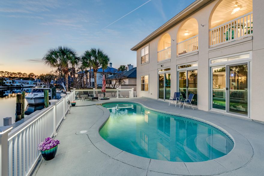 Tucked behind the private gates of the Bay Point community, this four-bedroom, four-and-a-half-bath WATERFRONT home is the definition of a coastal luxury dream. Reimagined with timeless, style and thoughtful detail, this home offers more than 3,600 square feet of beautifully curated living space, an incredible layout with multiple bonus rooms, a waterfront pool and a private dock perfect for having your boat in your back yard! Step inside and you're immediately drawn to the soaring high ceilings and the shimmering waters of the canal. The stunning modern kitchen is a showpiece of design and function, outfitted with a 48-inch range, waterfall-edge quartz counters, oversized kitchen island with a beautiful Quartz countertop, three ovens, wine refrigerator, and a scullery that dreams are made of! 

This waterfront home offers two bedrooms on the main level, including a waterfront primary suite with dual walk-in closets as well as a spacious junior primary suite. With two oversized flex rooms upstairs, the home easily adapts to your lifestyle, whether that means multiple home offices, a private gym, or playful spaces for the kids. There are two bedrooms upstairs and every bedroom enjoys the comfort of its own en suite bath, ensuring privacy for both family and guests. 

Outdoors, the property transforms into a private tropical escape. A saltwater pool is inviting for afternoons in the sun or evenings under the stars after a day on the boat. The boat dock offers composite wood decking for durability and a 7,000 LB boat lift. 

The Florida room offers a wet bar and a great place to enjoy the views year-round. Enjoy keeping your boat just steps away from your back door, ready to make a trip to Shell Island or to the open bay in just minutes. 

You will also love that this home boasts plenty of parking on the pavered driveway, perfect for entertaining! This home has an attached 2.5 car garage, perfect for storing your own vehicles as well as a golf cart - since Bay Point is one of the most golf cart-friendly neighborhoods in Panama City Beach, Florida. 

Life here means more than a beautiful home, it means mornings on the Nicklaus-designed golf course, afternoons at the yacht club or the marina, evenings dining out, and weekends spent on the water. Bay Point is where resort-style living meets the comfort of home, and this residence is a rare opportunity to experience it all. Start your life behind the gates of Bay Point in your own gorgeous waterfront estate!