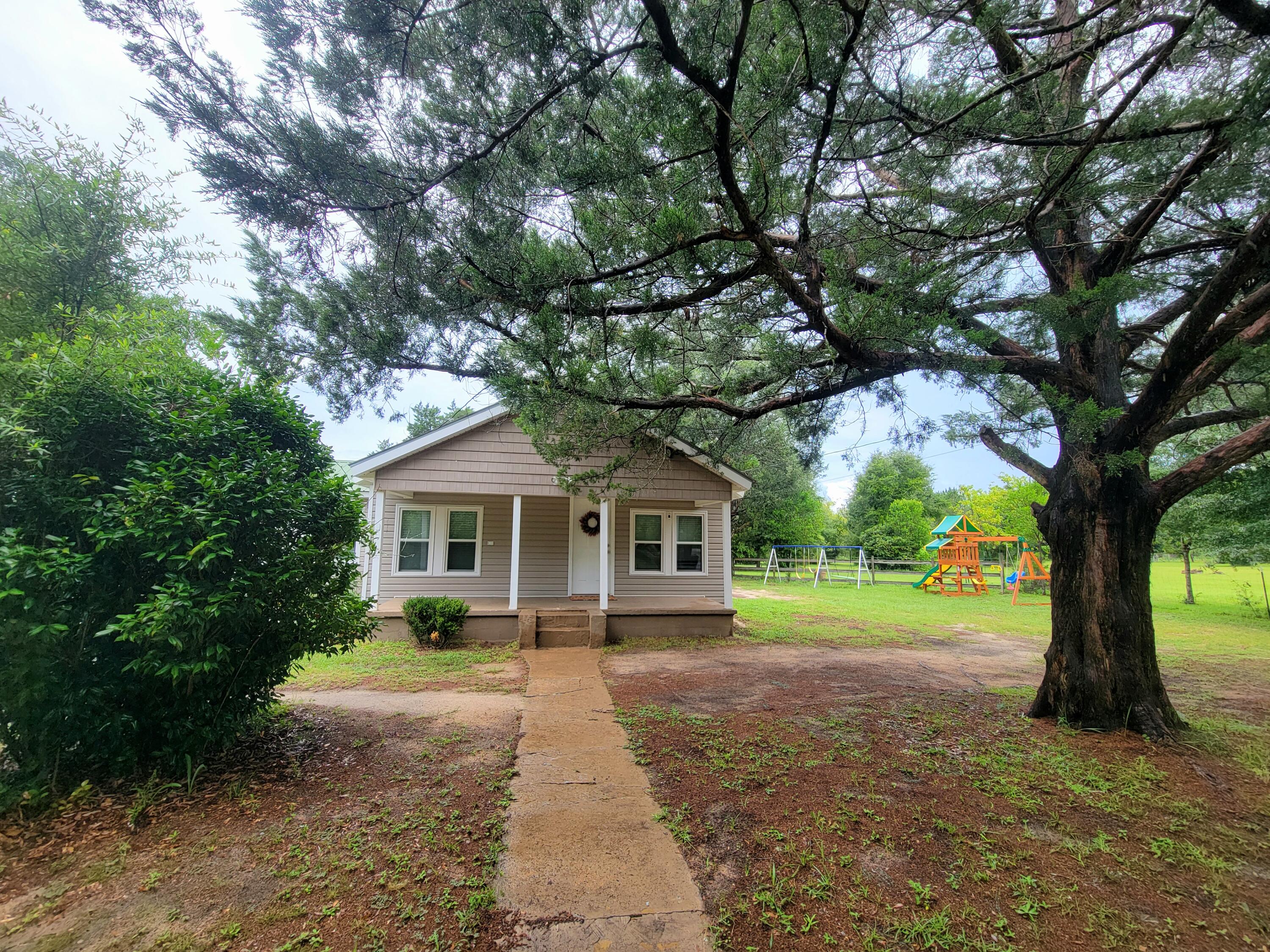 2.2 acres with the cutest ever country style home! Home was renovated in 2017 with new windows and doors. Also with Wi-Fi, HVAC and water heater; replaced fixtures in the bath and kitchen. Family-feeling home with living room and kitchen/dining area together includes stove, refrigerator and dishwasher. Much love and care given to the true wood floors; tile added in kitchen & bath. Large Master bedroom 14x12', with enlarged bathroom to accommodate both bedrooms. Bedroom #2 is just right for kids or to use as a guest room or hobbies. Laundry in separate building directly off the back porch complete with storage & window a/c. Has a two-stall horse barn with a lien-to on each side. Completely fenced pasture area on the north side of the barn and home. Bring your pets. NO HO
