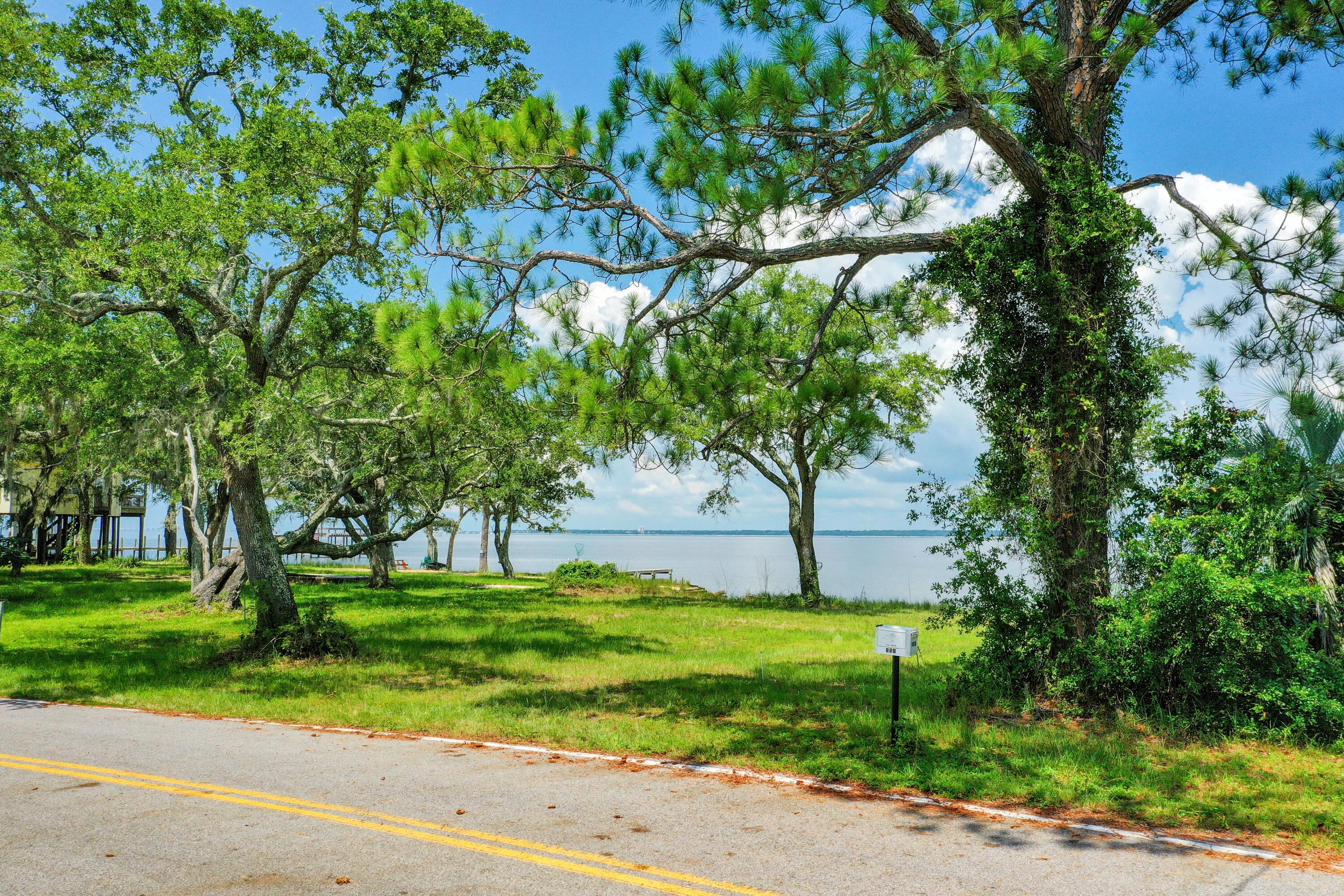 Serenity at last! Picture your waterfront dream home on this beautiful piece of property overlooking the Pensacola Bay! Escape from the hustle and enjoy the sunsets, fishing, boating, all of amenities that Florida has to offer! BONUS! There is a public boat ramp at the end of the street. A quick drive into Navarre/ Gulf Breeze or Pensacola, you are situated in a perfect location to enjoy your privacy and still have quick access to schools, bases, beaches, airport and shopping! If you have plans for waterfront, this is your spot!