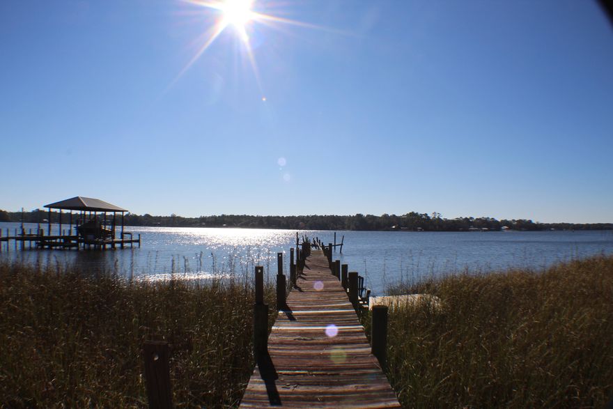 Live on the water at 100 Shoreline Drive and build your dream home. This homesite is a 1.84 acre, bayfront lot with 190 feet waterfrontage and private dock. Located on La Grange Bayou in the peaceful and secluded neighborhood of La Grange Shores, this lot is situated about 15 minutes from the 331 Bridge and just a 20 minute drive to the beautiful beaches of South Walton. An ideal homesite for anyone looking to build their dream house, enjoy life among the beauty of natural Florida settings, and capture endless serene sunsets on the bay. Pay no HOA fees! Minutes away from great shopping, dining, golfing and many other area amenities, as well as a short boat ride to the Destin Pass. Home currently exists on lot and will be included in the sale As Is. Buyer to verify all measurements.