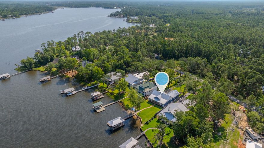 Immerse yourself in the tranquil beauty of this Lagrange Bayou waterfront property nestled along the serene Lagrange Bayou with the added advantage of no HOA. Bring the boat for the 30ft boat lift and deep water access. Enticingly designed, this custom-built home, constructed just two years ago, offers around 104 feet of waterfront access, providing a picturesque view and a sense of exclusivity. As you step inside, you will be greeted by the warmth of the hardwood floors and the charm of a chef's dream kitchen adorned with lavish granite countertops and high-end stainless steel appliances. Every corner of this home exudes elegance, with a walk-in closet leading seamlessly to a well-appointed laundry room, complete with extra custom cabinets and a sink vanity accentuated by captivating brick-styled flooring. .. The private dock beckons for leisurely boat rides, boasting deep water access, and is conveniently located just a 10-15-minute boat ride away from the North beach social and The Bay restaurant, offering a delightful combination of dining and recreational opportunities. The westward-facing backyard is thoughtfully designed to provide an ideal setting for savoring breathtaking sunsets and hosting summer gatherings, complete with a custom-built tiled summer kitchen on the back deck, featuring a sink, gas cooker, and grill. Revel in this new oasis of relaxation and luxury, knowing that this property is positioned in a flood-free zone as confirmed by the flood certification survey.