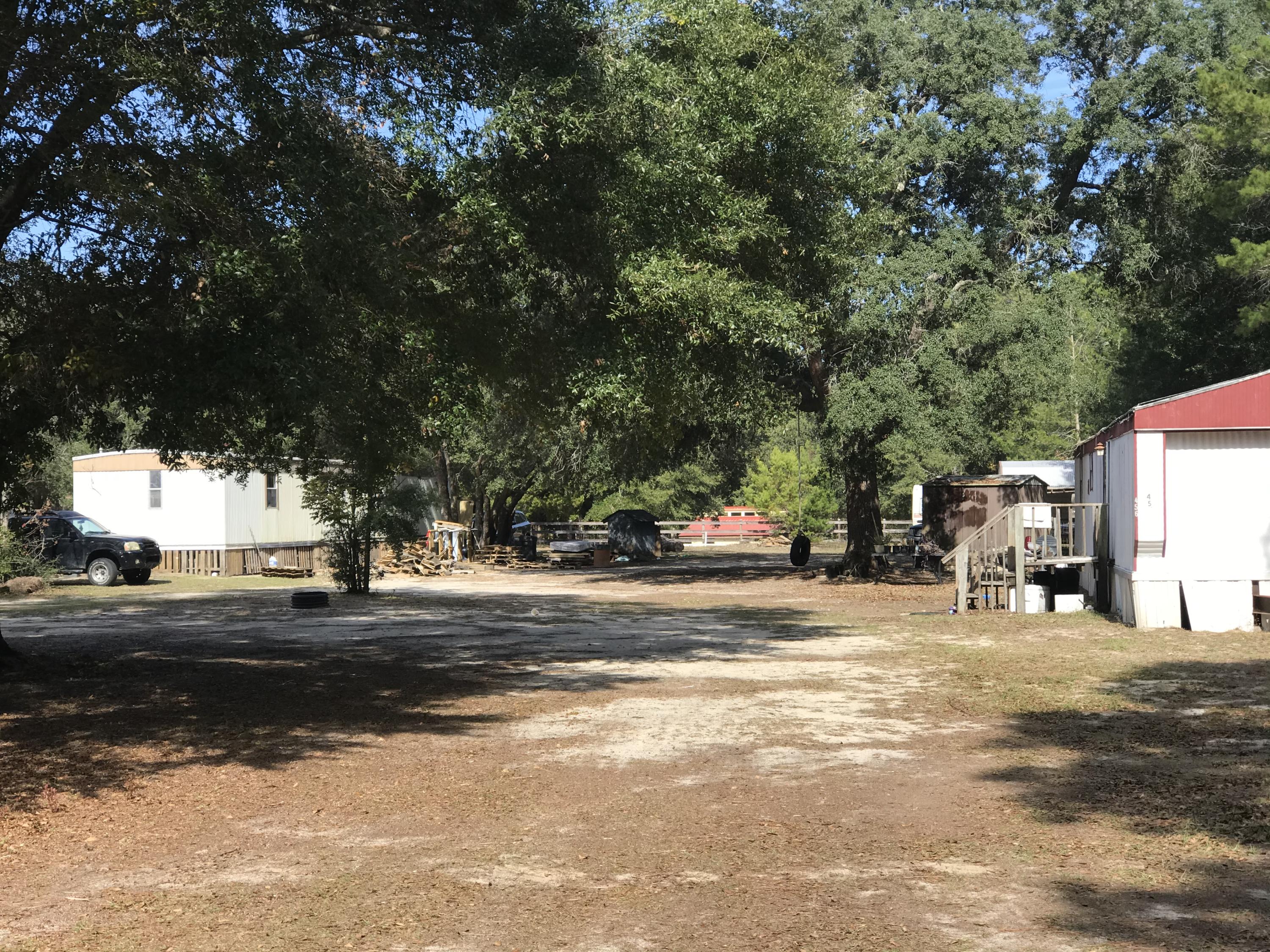 Investors special.. Two mobile homes and .43 acres on a beautiful high and dry lot located in Freeport just outside city limits. Water and sewer are available. This property can bring in over $1400 a month and easily made HUD compliant. There are two mobile homes on the property, one is a two bed two bath and the other is a 3 bed 2 bath. the 2 bedroom has window units currently and the 3 bedroom has a new AC unit.