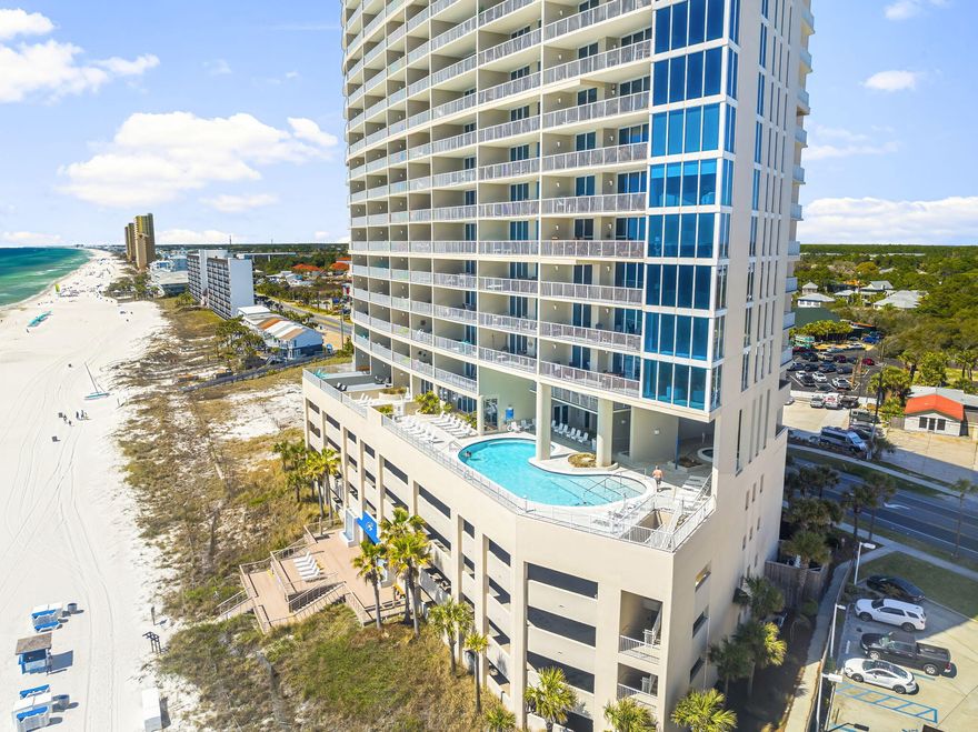Looking for 30A-inspired living in Panama City Beach? Look no further than Palazzo 207--a beautifully updated 3-bedroom, 3-bathroom Gulf-front condo that combines luxury, comfort, and convenience in one exceptional package. Ideally situated just yards from the second-floor fitness center, this unit has been thoughtfully reimagined from front door to balcony. As you enter, you're welcomed by a striking combination of tile and Bella Cera luxury wood floors that guide you through the open, light-filled space. Floor-to-ceiling windows draw your gaze to the balcony, where expansive Gulf views create the perfect backdrop for coastal living. The layout is as functional as it is stylish.  One guest suite offers a private en suite bath--perfect for visitors. While a second bedroom features a trundle bed for additional flexibility. A reimagined storage area with frosted glass doors adds a modern, practical touch. The kitchen is a true showpiece, featuring white shaker cabinetry with soft-close doors and drawers, double-thick granite countertops, a farm-style sink, and high-end stainless steel appliances, including a GE WiFi-enabled cooktop and oven. There's even a Whirlpool trash compactor for added convenience.
Adjacent to the kitchen, a recessed beverage center with a Danby Silhouette dual-door fridge is perfect for entertaining. The dining area showcases a solid wood table and chairs, while the living space invites relaxation with its leather sectional and custom floating media shelving beneath a mounted 65" TV. The primary suite is a serene retreat, complete with a king-size bed, padded headboard, solid wood furnishings with soft-close drawers, and breathtaking Gulf views. The en suite bathroom has been completely redesigned to include a double vanity and a spacious corner shower with both side and waterfall showerheads. A tucked-away laundry center with LG washer and dryer adds everyday convenience.
To top it all off, this unit includes a private storage closet, making beach life even easier. With its ideal location, tasteful updates, and elegant coastal charm, Palazzo 207 is the perfect opportunity for a primary residence, second home, or luxury rental. Schedule your private showing today and experience the best of Gulf-front living.
