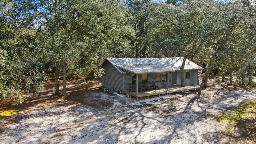 ATTENTION HUNTERS, FISHERMAN AND OUTDOOR ENTHUSIASTS! This is your opportunity to own a custom built cabin on a private 50 acre natural spring fed lake!  All the hard work has been done. Cabin is move in ready and is being sold fully furnished!  Sale includes a 2020 Bass Tracker pontoon boat, trolling motor, boat cover & 60 HP motor valued at $28,000.00.  Don't miss this opportunity to own one of NW Florida's premier properties.  Big deer country.  Great bass, bream & crappie fishing.  Turkey hunting too!. The cabin has been totally reconstructed from the ground up.   Barn renovated too.  Much love went into the renovation project and it shows! Renovations  completed January of 2021. Must see to believe.  It's awesome!  Private and secluded.   shown by appt. 24 hours notice required