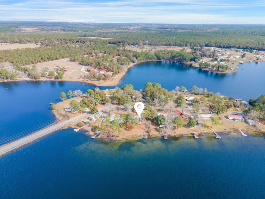 Waterfront property on beautiful Kings Lake! This lot is over half an acre with approximately 100ft of water frontage. Great spot to build an amazing lakefront home. Property has covered parking, 2 storage sheds, a working well located in the back yard and a BRAND new septic installed. No HOA and quiet seclusion make Paradise Island a very desirable location. The mobile home is mostly furnished, including a washer/dryer and is perfect for a weekend lakefront getaway or fishing trip.  A perfect fixer upper, sold as is.