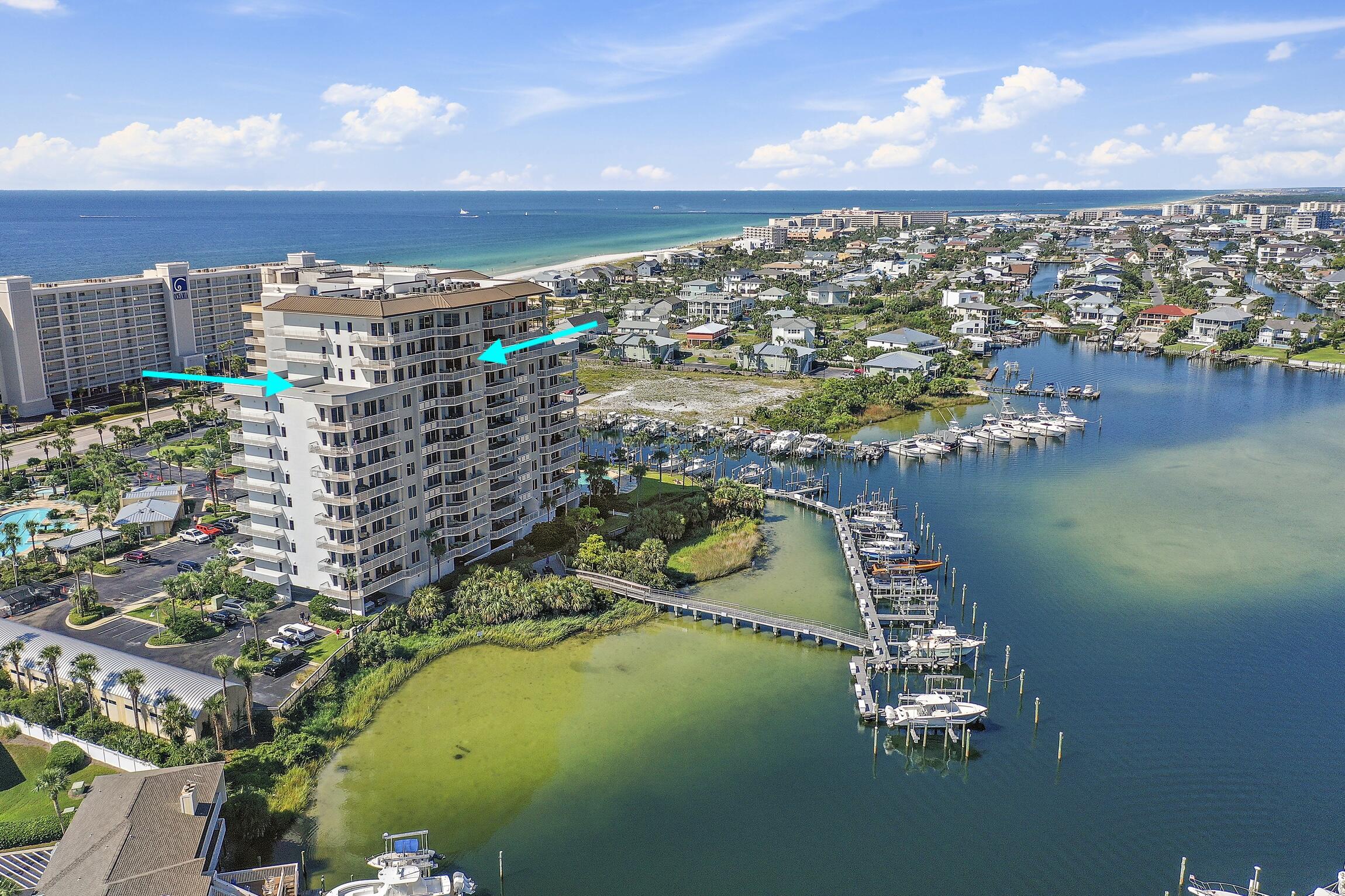 Penthouse suite with expansive views of the Gulf and Harbor, 2 master suites, boat lift, and garage!!! This massive, open condo has over 3200 sq ft inside AND a 2000 sq ft rooftop patio. Updated with NEW LVP flooring in the bedrooms and living areas, new backsplash and hood vent in the kitchen, and updated lighting and fresh paint throughout! Beautiful views from the living and dining areas, kitchen and master bedrooms. Watch the sun rise over the Gulf and set over the Harbor from your private rooftop patio. Harbor Landing has a pool exclusively for owners and a separate pool for all occupants, private beach access, fitness room, dock and more! Boat lift is rated for 16K lbs and also holds a jet ski. Large laundry room with storage. Owners closet for additional storage. Private garage.