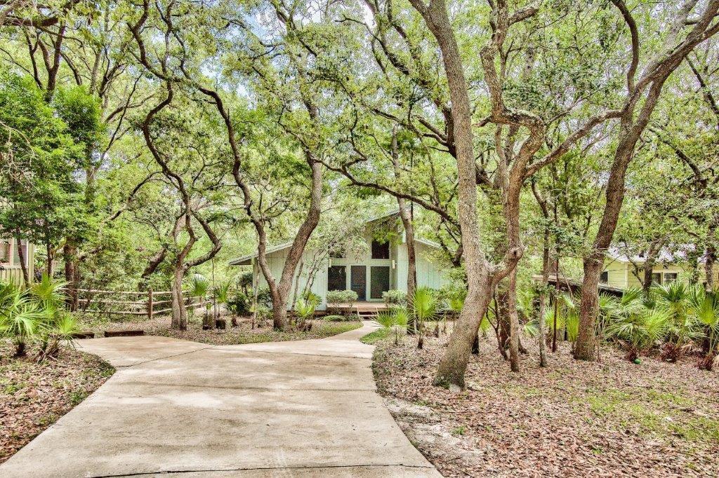 Classic Florida cottage on coveted Canal Street in historic Seagrove Beach with no HOA! Nestled on a sizable, canal front site provides for room for expansion.  Serene setting canopied with large oaks, hickorys, magnolias approx. only 400 yards to one of several nearby beach accesses to undisputed, County owned beach. Walk or bike quaint connector roads  to nearby shops, restaurants, Publix ,  Seaside and Watercolor.  Interior features vaulted ceilings, large windows and fireplace in living area. Relax on 12' x 25' screened rear porch in serene setting overlooking canal and preserve woods directly across canal.  New metal galvalume roof. Heat pump, HVAC, hot water heater relatively new and in good condition. There is a deep water well onsite. Family Beach House for many years, most