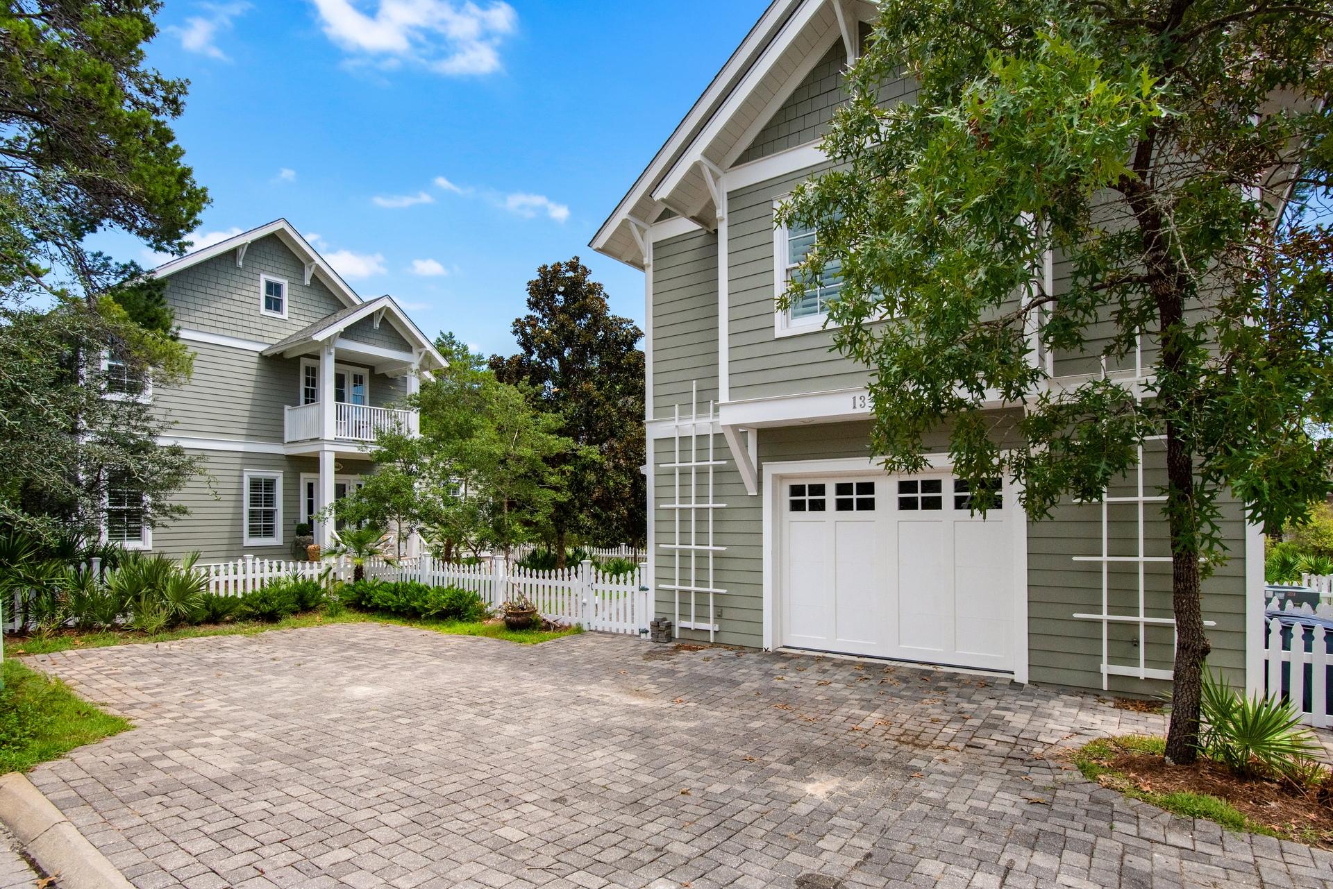 Beautiful custom home that is truly one of a kind!  Located on a coveted 150 x 60 lot overlooking Deer Lake State Park, this homesite boasts a main house, separate carriage house/garage, parking spaces, patio with fire pit, spacious fenced yard, and plenty of room for a private pool.  This unique property has only had one owner and was designed with timeless details such as white washed wood floors, marble counters, antique sink cabinet in powder room and carriage bath, unique antique marble counter on wet bar, and much more!  The main level features a spacious open living/kitchen/dining space with vaulted wood ceiling and gas fireplace.  The master is also on the main level and boasts a beautiful marble bath, walk-in closet, and attached office.