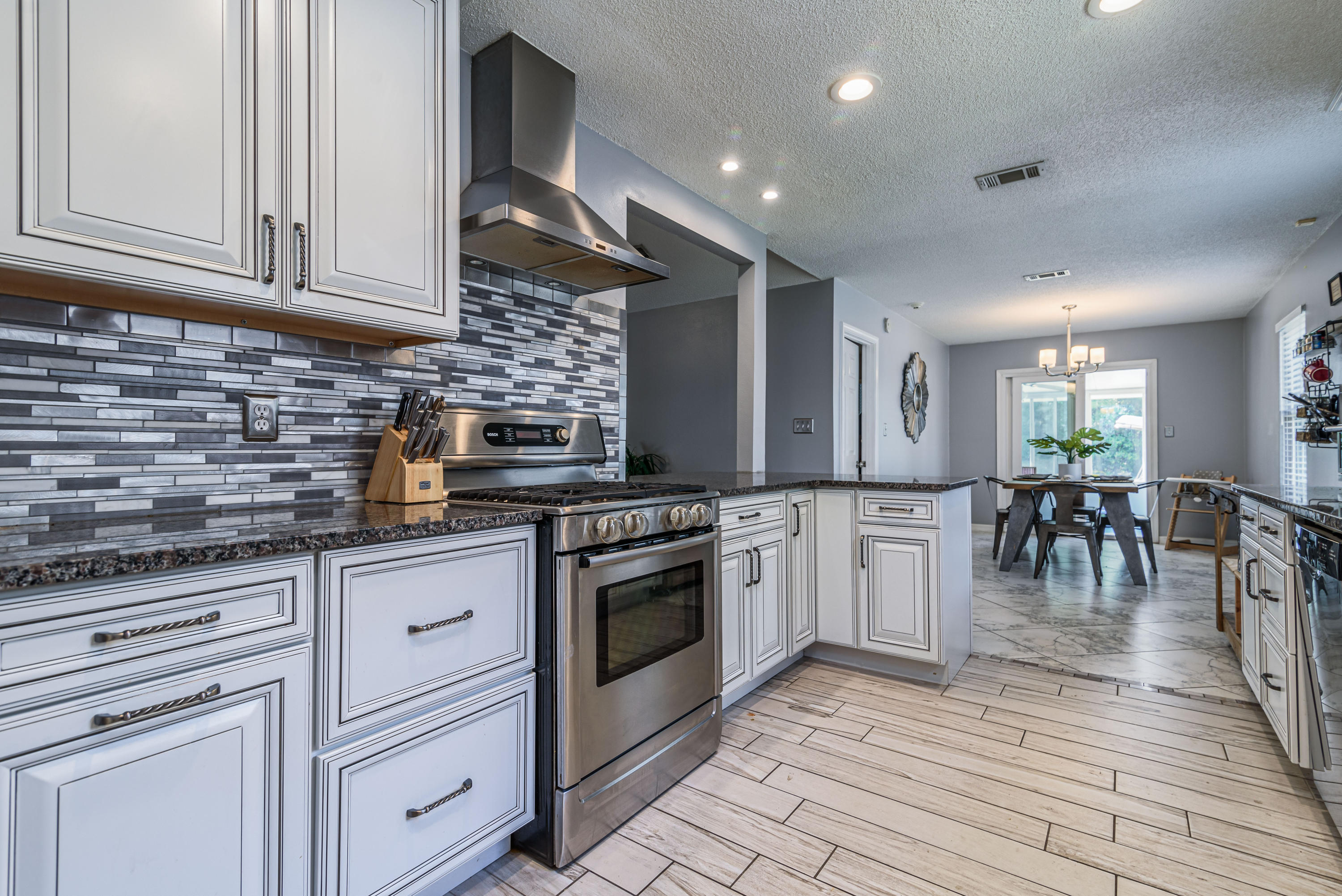 The kitchen is the heart of the home! If that is how you feel, you will want to check out the extensive upgrades in this quality home! Complete kitchen remodel with beautiful finishes. Beautiful custom cabinetry with soft-close feature. This is a chef's dream! Bosch gas stove, dishwasher, and refrigerator with water/ice all in stainless. The exterior has $30,000 of added Hardi-plank and high impact Simonton windows with LIFETIME warranty (great Hurricane protection). They look fantastic and provide superior storm protection. The master and one guest bedroom have new wood flooring. Additionally, the home has a newer $7000 HVAC system and newer hot water heater.