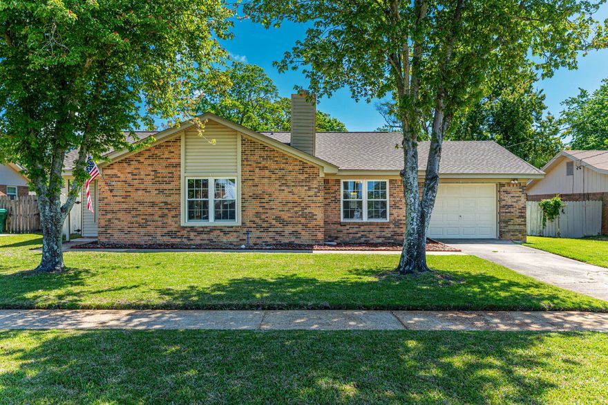 You will fall for this charming, well-kept home! Located just West of Hurlburt Field, this home features a large open great room centered around a beautiful fireplace, and laminate flooring in the living area. A galley kitchen contains some stainless steel appliances for every chef. This home underwent meticulous care to get ready for its next owners, with brand new paint, carpet, and touch-ups throughout. Age of major appliances and structures include 2019 roof, 2020 HVAC, 2024 water heater, and a new electrical panel in 2022. The garage features 220 amp and would be perfect for a workshop. Situated on a huge lot perfect for backyard BBQs, you don't want to miss this home. Schedule your appointment today!