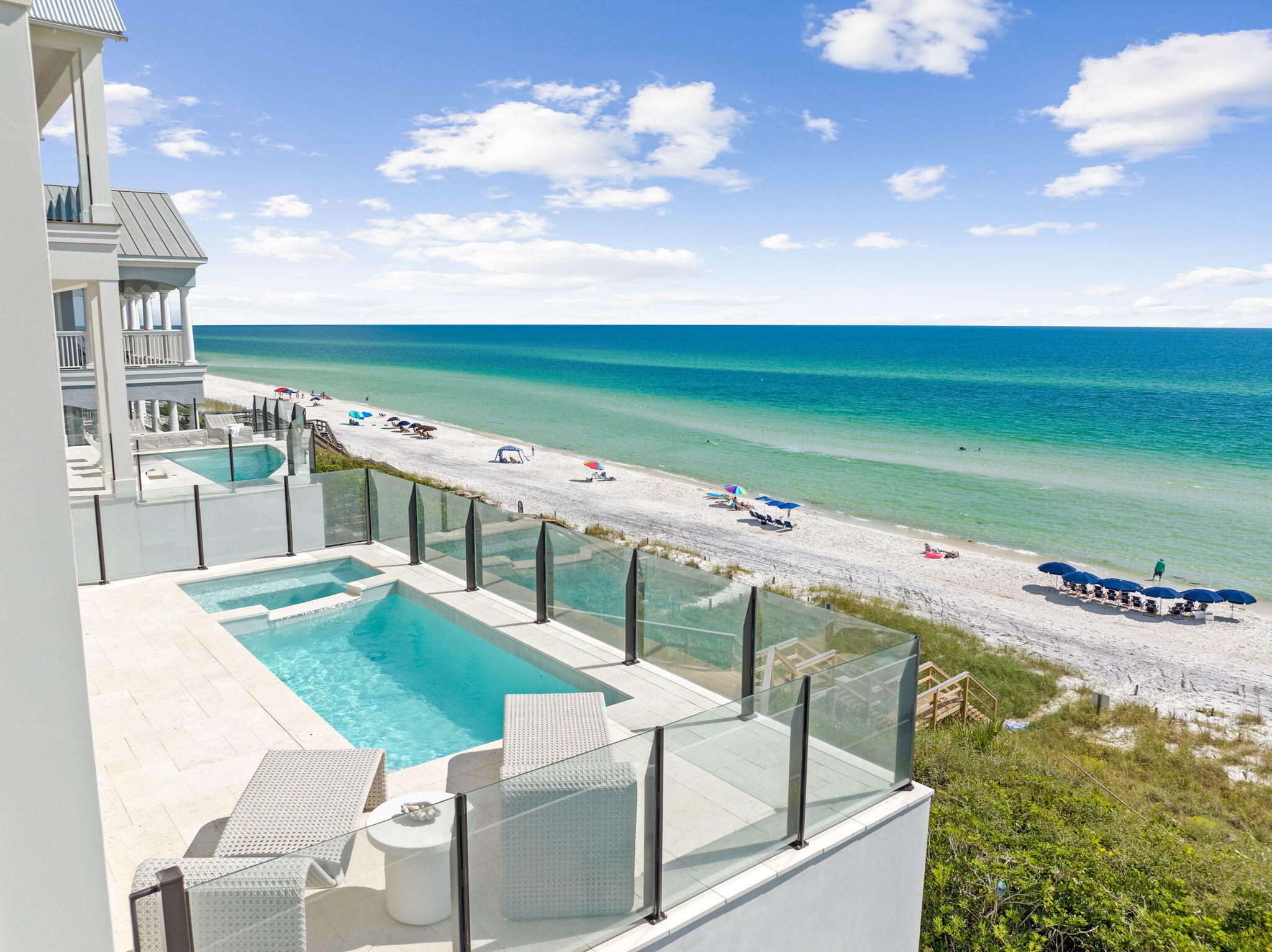 Reigning atop the dunes of Seacrest Beach, this iconic Gulf-front estate affords unprecedented coastal living. This new construction home is prominently situated between Camp Creek Lake and Alys Beach along 30A in Northwest Florida. This one-of-a-kind manor showcases a coastal design vision brought to life with the highest quality materials and finishes. Overlooking one of the most sought-after beaches in the US, the breath-taking views of the sugar white sands and the emerald green hued waters can be enjoyed throughout all three levels of the home. A perfectly planned floor-plan paired with exquisite design creates an unparalleled experience of seaside living. The immaculate and stately presence is appreciated upon initial approach. The front elevation is moored by a courtyard bordered with lush landscaping and a serene water feature connecting the outdoors to both the main home and carriage house. Upon entry, visitors are greeted by the grand foyer. On the ground level of the home you will locate a recreation room, fully equipped theater, oversized bunk room, junior bedroom suite, powder bath and the first of three laundry facilities.

The striking stairwell provides ample natural light which highlights the tumbled white coral stone flooring on the ground level while granting access to the main level of the estate. Views of the water immediately attract attention as you traverse into the expansive great room. The chef's kitchen is situated on the northern end of the great room. Natural quartzite countertops, luxury gas range, built-in refrigeration, sprawling double islands and a spacious dining space complete the main areas of the kitchen. A scullery is located behind the cooking area for preparation and storage while entertaining. The fully equipped wet bar is situated between the kitchen and dining space. The living space is anchored by a grand fireplace and natural oak beams on the ceilings. A powder bathroom and two additional guest suites are located on this level.

Navigate through the great room to the thoughtfully configured outdoor living area showcasing a private pool, spa, fully equipped summer kitchen, an abundance of porch space, and a private beach walkover with access to the expansive beach frontage.

The third level is home to a sprawling primary suite with sleeping quarters, a large closet, and an impressive ensuite bathroom showcasing exceptional water views. The heart of the third floor is home to a cozy living area providing a retreat for the evenings before going down for the night. Two additional guest suites and the second laundry facility complete the third level.

The carriage house is equipped with a full-service kitchen, dining area, living area, stackable laundry and two more fully appointed guest suites. This space is perfect for your guests who desire a bit more privacy.

This home epitomizes the luxury lifestyle of 30A while still being geographically poised minutes from the surrounding new urbanism communities of Seaside, Watercolor, Alys Beach and Rosemary Beach. Inquire today and start living the coastal lifestyle you deserve.