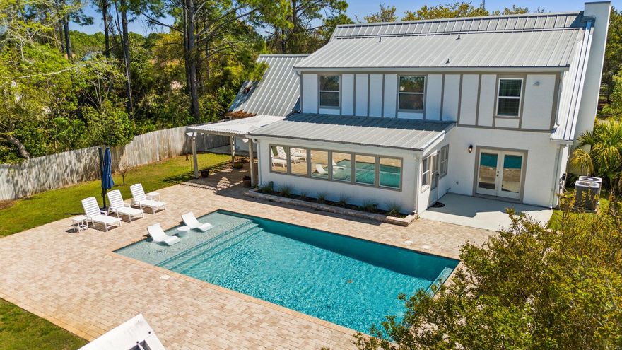 Discover 111 Moonlight Dr, a stunning 4-bedroom, 3-bathroom home in a quiet, golf cart-friendly neighborhood on the West End of Panama City Beach. Just half a mile from dedicated beach access with easy access to 30A, this home is perfectly located. Inside, enjoy a spacious living room with exposed wood beams and built-in bookcases, a kitchen with an island and stainless steel appliances, and a sunroom with a charming tongue-and-groove ceiling. With dual A/C units, two hot water heaters, and fresh professional paint, it's truly move-in ready. Outside, a 2023-built pool and paver deck create a backyard oasis. A 224 sqft auxiliary structure with electrical is ready to be finished as an office or pool house. Swing set and pool furniture included!
