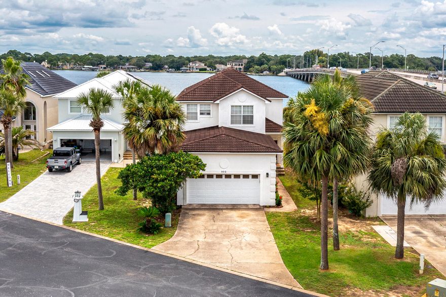 Waterfront property in Lighthouse Point sits on the Bayou off Choctawatchee Bay.  This spacious, 4 bed, 3 bath home is open and bright with water views the moment you walk in.  Upstairs there is an Oversized Master Suite that overlooks the water, with a huge walk-in closet, tile shower and double vanity with tons of cabinet space.  There are also 2 additional bedrooms and a full bath.  On the main level there is a second Master Suite Option.  There is a private dock with a boat lift, perfect to take your boat on a short trip to the nearby waterfront restaurants and Crab Island.