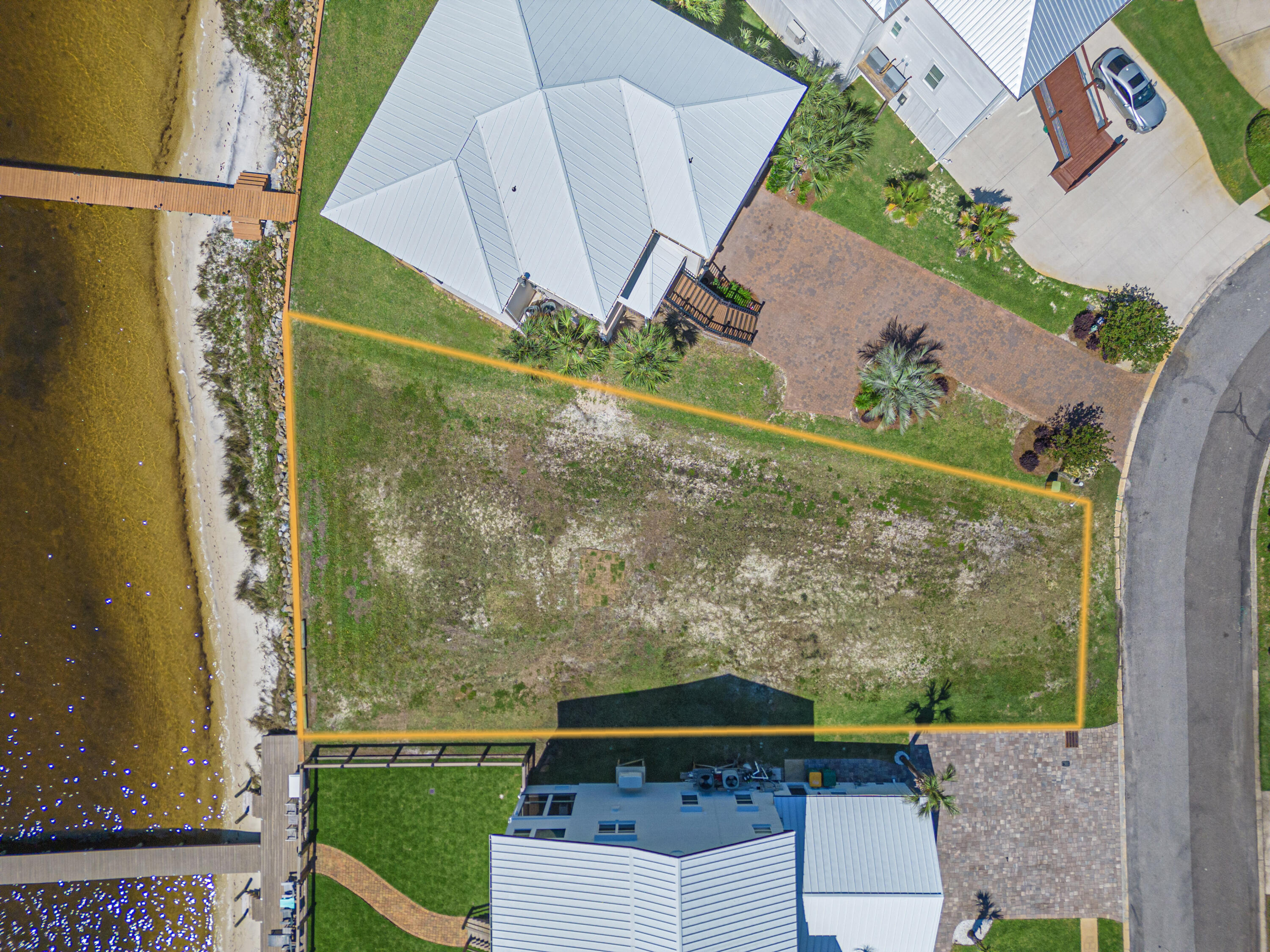 Discover the perfect canvas for your dream home on this stunning, cleared waterfront lot. Enjoy breathtaking, unobstructed views of Santa Rosa Island and the Gulf of Mexico. With a seawall already in place, you'll have access to deep water, ideal for boating enthusiasts. The neighboring dock boasts a depth of 6 feet, ensuring easy navigation. The HOA also has a dock, beach, gazebo and small boat storage as well! Experience the unparalleled beauty of sunsets from your future home and relish the refreshing summer sea breezes. This exceptional lot offers a rare opportunity to create your personal paradise. Don't miss out on building your dream home in this idyllic setting. The seller also has a set of houses plans that were done just for this lot!