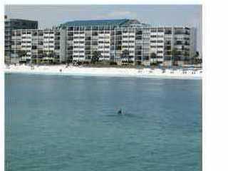 Fully furnished condo (except kitchen),with updated furniture, located on the 7th floor with view of Gulf from Kitchen, Dining, Living Room & Master bedroom. Tile floors in living areas and carpet in bedrooms. Kitchen with tile counters, back splash,& breakfast bar, washer/dryer, mirrored wall,open floor plan, wall to wall sliding door that leads to large tiled balcony overlooking heated pool & gulf,hurricane shutters,steps from the beach,floor to ceiling window in master bedroom. Gated entry, exercise room, owners lounge with kitchen,private beach access. NO PETS PER ASSOCIATION, NON-SMOKING.