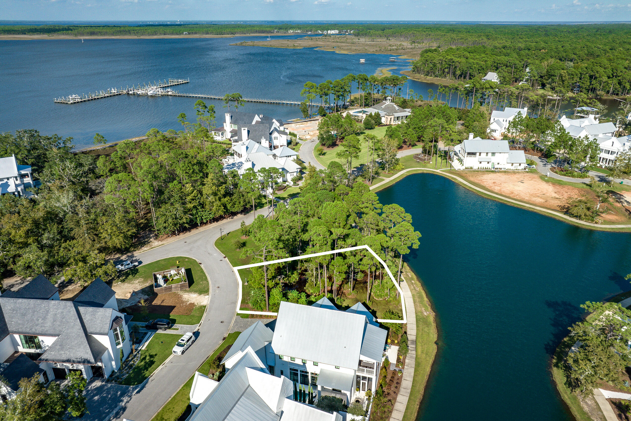 Rare opportunity to acquire a vacant homesite in the waterfront enclave of Churchill Oaks! Prominently situated on a corner, and adjacent to a designated green space, this large lake front lot offers beautiful views from every direction, including a peek of the bay through the nature preserve. Design and build your custom dream home in south Walton's most desirable bay front community! A preliminary design study by Matt Savoie conveys with the property. Tucked away amongst native vegetation and the calm waters of Hogtown Bayou, Churchill Oaks offers a lifestyle of elegance and appreciation of nature. Once inside the stately gated entrance, magnificent coastal homes accentuate southern architecture under a canopy of old oak trees. The 40-acre community is comprised of 87 homesites and some of the best amenities in South Walton. The latest amenity to the community is a deep-water, private marina. The marina project includes 36 private boat slips, paddle board storage decks, a fish cleaning station, shoreline stabilization + more! The Churchill Oaks Clubhouse is an outstanding 8,000 square foot amenity situated on a point on the Bay with stunning views. Three pools, exercise room, outdoor bar, fully equipped media room, commercial grade kitchen, bath and locker rooms, and large gathering spaces are all found at the Clubhouse for owners and their guests to enjoy. * Please verify with listing agent the total New Buyer fees due at closing.