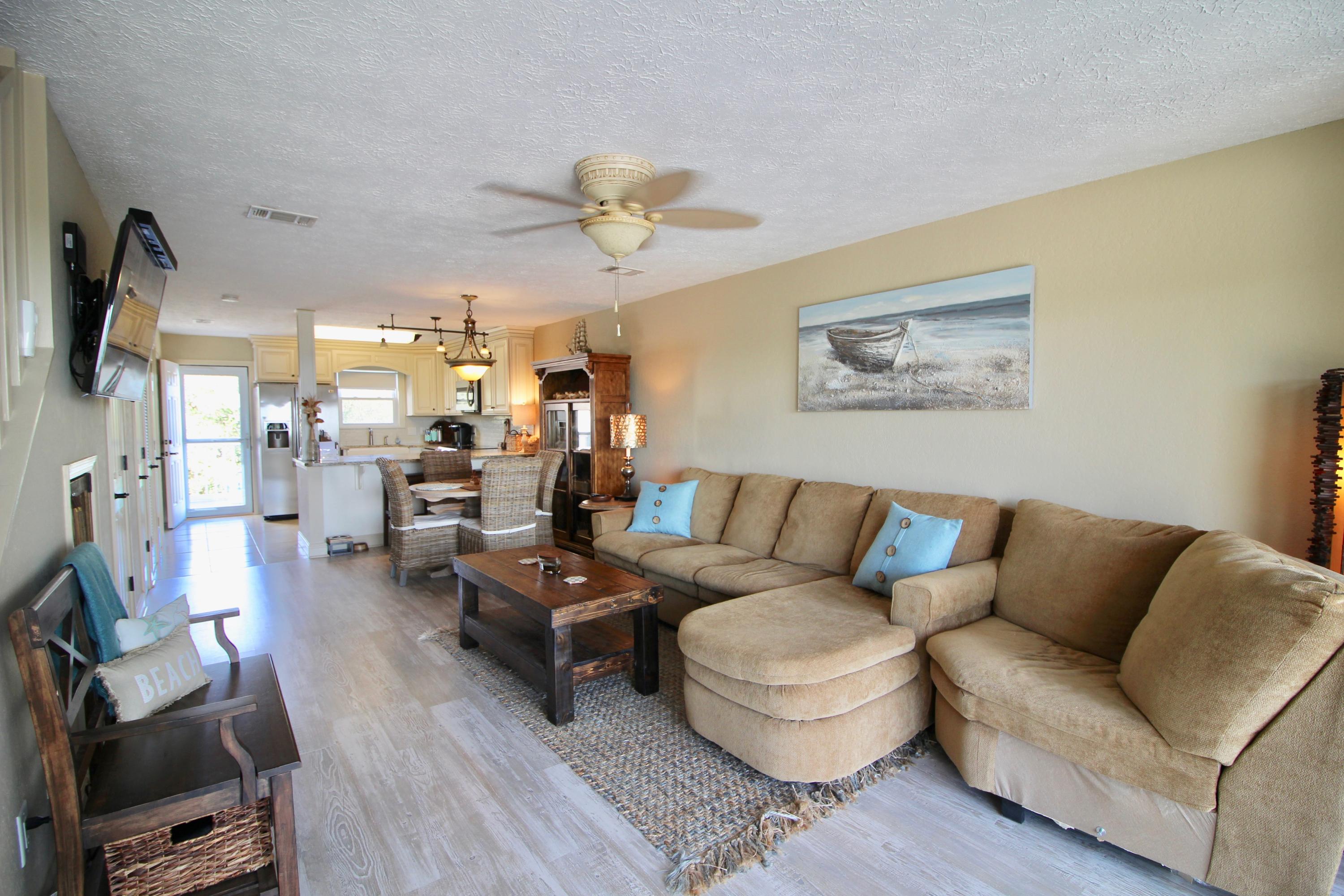 Updated town house with fabulous views of the Gulf! Boardwalk to beach is right across the street. Hardwood floors throughout, steam shower in Master, induction cooktop, great refrigerator, nice fenced yard, garage is deep and can fit 2 cars. This home is in great condition. Room sizes are approximate as I am waiting for actual measurements.