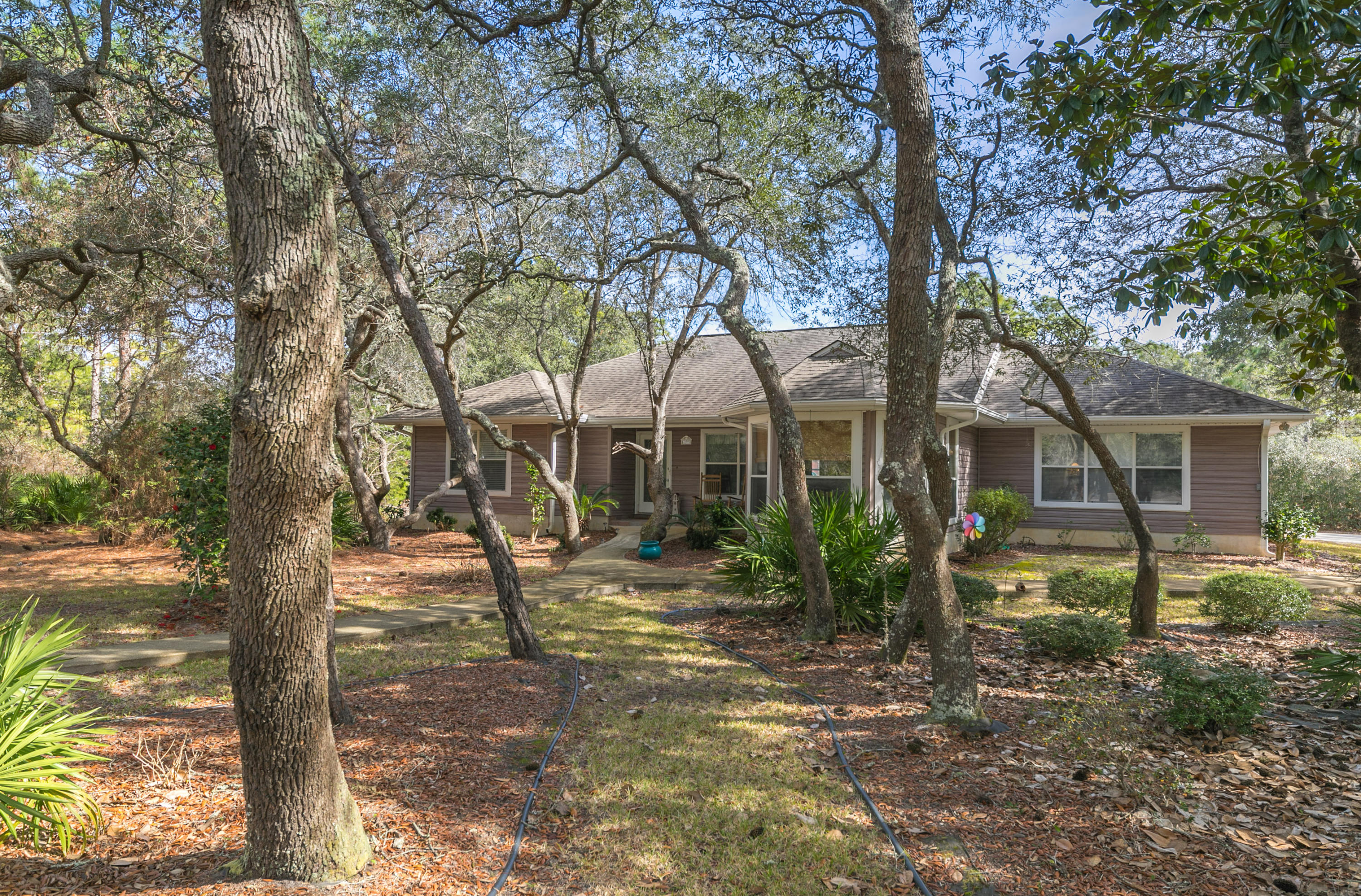 Beautiful one acre corner lot filled with hydrangea, camellia and azalea bushes surrounded by Spanish oaks.This three bedroom two bath house is situated on Mack Bayou conveniently located to shopping and entertainment without being in a neighborhood with association dues. Popular split floor plan with the master on one side and the other two bedrooms on the other side of the house. Florida room between the house and the garage has been closed in and could be used as an office, playroom, bonus room etc. (current owner used for daycare). Contact us today for a private showing.