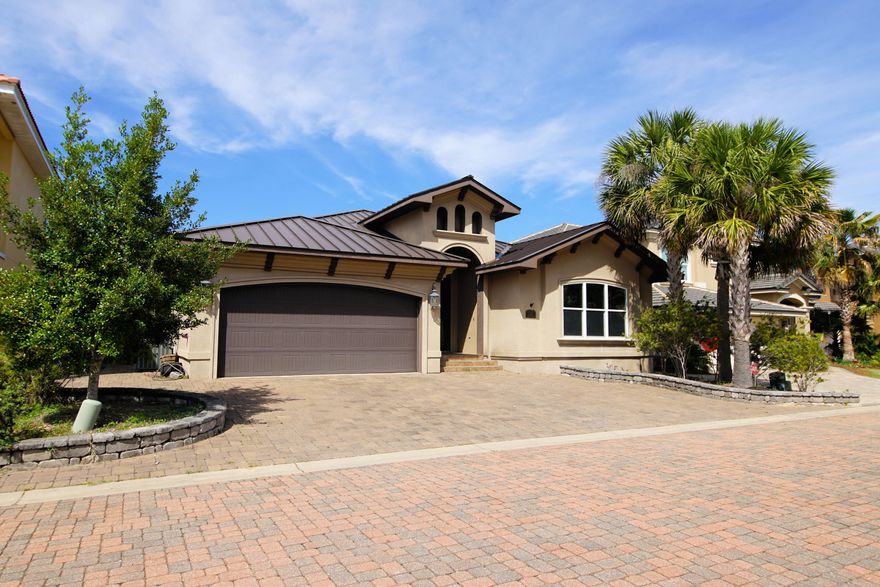 Your own Tuscan Villa in the heart of Shalimar FL! You will enjoy this exceptional home nestled in a gated community with paver streets and a neighborhood waterfront park. As soon as you walk up to the incredible custom doors you will know this home is special. High ceilings, crown molding, custom plantation shutters, metal roof and spray foam insulation that keeps utility bills down. PLUS there's a lovely waterview from the master bedroom, backyard, great room, large screened porch and kitchen. Oh my what a kitchen! This is a true chef's dream. The highlight is the commercial grade gas stove with pot filler. Don't miss the gorgeous glass tile backsplash, tons of granite counter space, custom cabinets, breakfast bar and pantry. Only 3.5 mi to Eglin AFB and across from the marina.