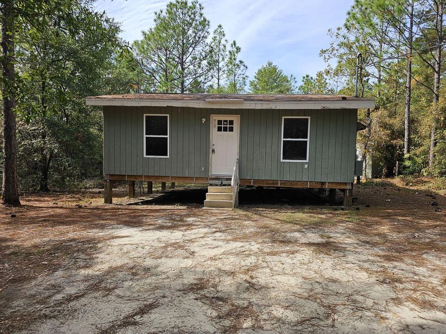 A DIY dream, or investor special!
This Cozy 2 bedroom, 1 bath Cottage with an open concept living room/kitchen area is sitting on a beautiful 4.9 +/- acre wooded lot, giving privacy while still being centrally located minutes away from Hwy 90, an I-10 exit, Defuniak Springs, Crestview, and Niceville.
Although this home is a work in progress, its freshly painted, and fitted with new ceiling fan light fixtures, a new electric oven, a new side by side refrigerator with bottom drawer freezer, a new one and done washer/dryer, a new shower, and new vinyl flooring partially installed, 
it also comes with a new sectional sofa!