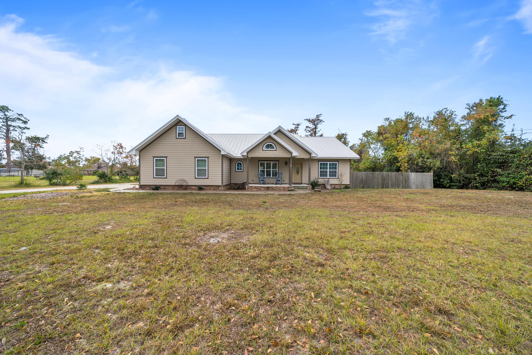 This lovely single-level, 2017-built home sits on an incredible 1.23 acres in the middle of town! Offering NO HOA and situated perfectly between Kings Point and Sweet Bay, you're going to love the freedom of a newer constructed home with land and room to grow. The best part of this home, other than the location, is the 24' x 48' DETACHED WAREHOUSE in the back yard. The possibilities are endless for this additional structure! This build has spray foam insulation, electrical, is connected to the private well and offers 4 - 12' roll-up doors with a drive-on vehicle lift. Whether you want to have a massive man cave, a chic she-shed, a golf simulator, a place to store toys...anything is possible with this detached garage! This home was built extremely well with 2'x6' exterior walls, has low-E rated 140mph windows, is completely spray foamed to keep your electricity bills lower and offers 3 bedrooms, 2 baths, a home office area and an attached 2-car garage. Keeping on one single-level, you'll enjoy this home for years to come and is even handicapped accessible with wider doors and a roll-in shower. High and vaulted ceilings can be found throughout maximizing the space this home offers! Top of the line HVAC is featured in this home as well as additional attic space that is great for additional storage or potential room to grow. As you step into the home, you're greeted with vaulted ceilings and bright interiors. With lots of windows and an open concept, this great room is great for entertaining! A home office space is located at the entry way and there are French doors leading out from the living room to the covered back patio. A breakfast bar is great for being included with your guests when cooking and this kitchen features sleek granite countertops and wood cabinetry. A breakfast nook and pantry are just off the kitchen and lead to the primary suite. The primary suite overlooks the large back yard and features a tray ceiling, soaking tub, oversized roll-in tiled shower and spacious walk-in closet. The 2 guest bedrooms and shared guest bath are on the other side of the home and offer a spacious layout and a true split floor plan. At 1.23 acres, this property gives the ability to make this into your dream homestead. Imagine a pool in your back yard, a pickleball court, a large garden providing your own vegetables, a workshop for your thriving business - and SO MUCH MORE! The detached garage gives so many options and to be in the center of town with this kind of land and amenities is remarkable! Make this dream property your dream home TODAY!